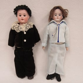 PAIR OF BISQUE SHOULDER PLATE BOYS: