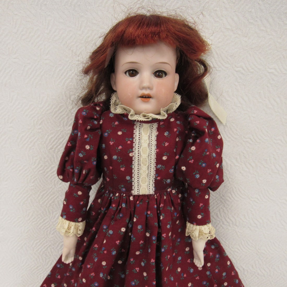 17 IN. ARMAND MARSEILLE:: BISQUE SHOULDER HEAD MARKED 370/AM5/OX D.E.P., BISQUE SHOULDER HEAD (NO DAMAGE) SLEEP EYES, OPEN MOUTH WITH TEETH, KID BODY WITH LABEL "SUNSHINE" RIVET JOINTS AT SHOULDERS (ARMS REPAIRED), HIPS & KNEE