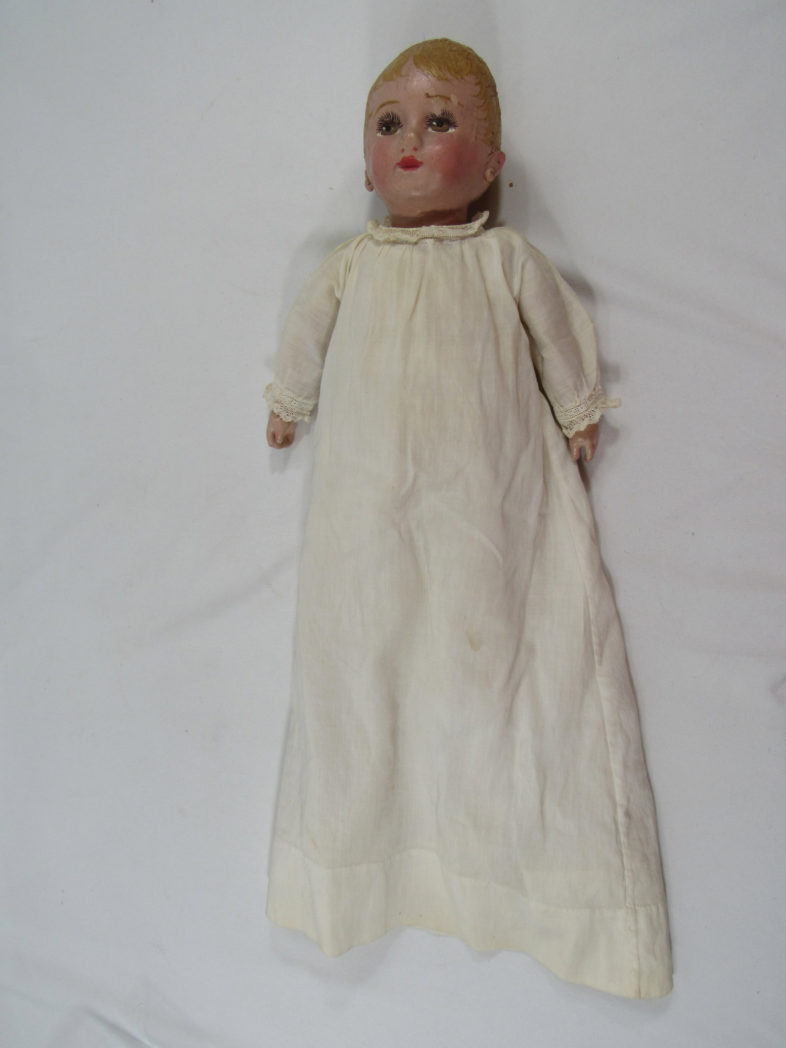 13 IN. CHASE BABY DOLL:: CLOTH PAINTED WITH OIL PAINT. NO REPAINT BUT THERE IS SOME CHIPPING & CRACKING OF THE PAINT, CLOTHING MAY BE ORIGINAL