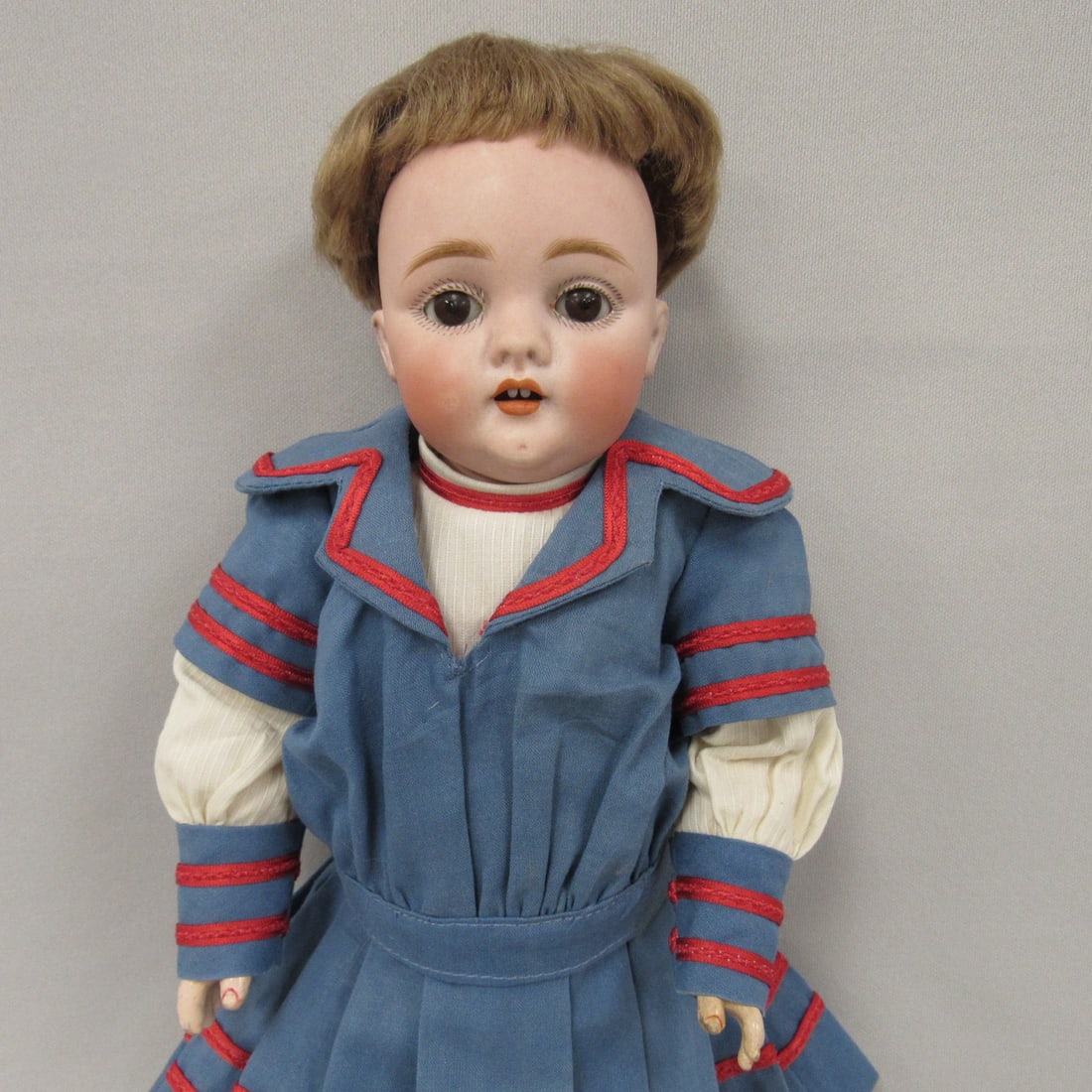 12 IN. KESTNER 143 CHILD:: BISQUE SOCKET HEAD (PERFECT) INCISED A MADE IN GERMANY 8. 143, SLEEPING BROWN GLASS EYES, BLUSHED CHEEKS, OPEN MOUTH WITH 2 UPPER TEETH, ORIGINAL JOINTED KESTNER BODY (GOOD ORIGINAL FINISH) WITH RED "