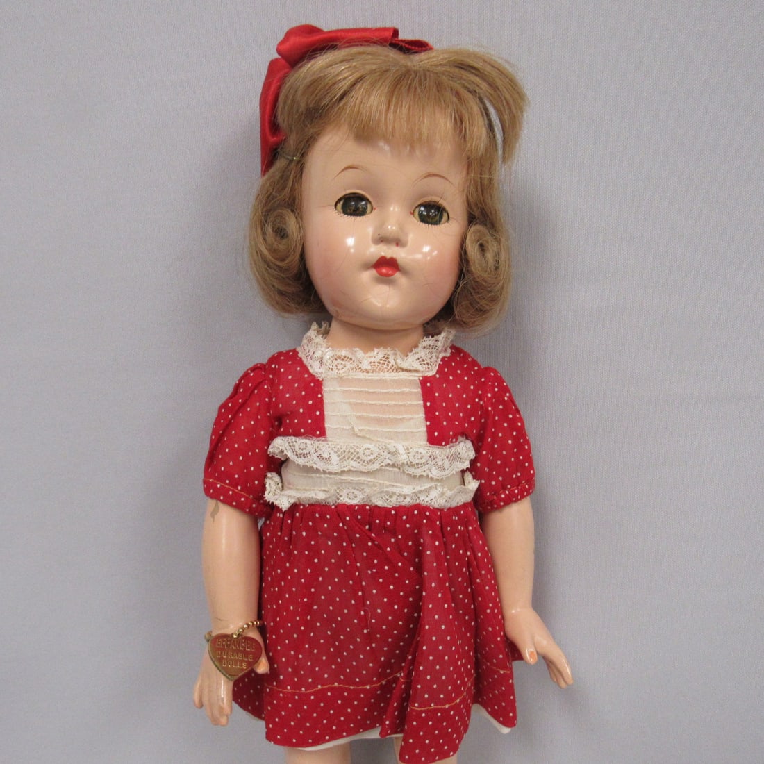 14 IN. EFFANBEE 1940'S "LITTLE LADY":: MARKED ANNE SHIRLEY. ALL ORIGINAL WITH BRACELET & TAGGED DRESS, HUMAN HAIR. COMPO IS IN GOOD CONDITION WITH SCUFFS ON THIGHS & ARMS, LIGHT CRAZING ON FACE
