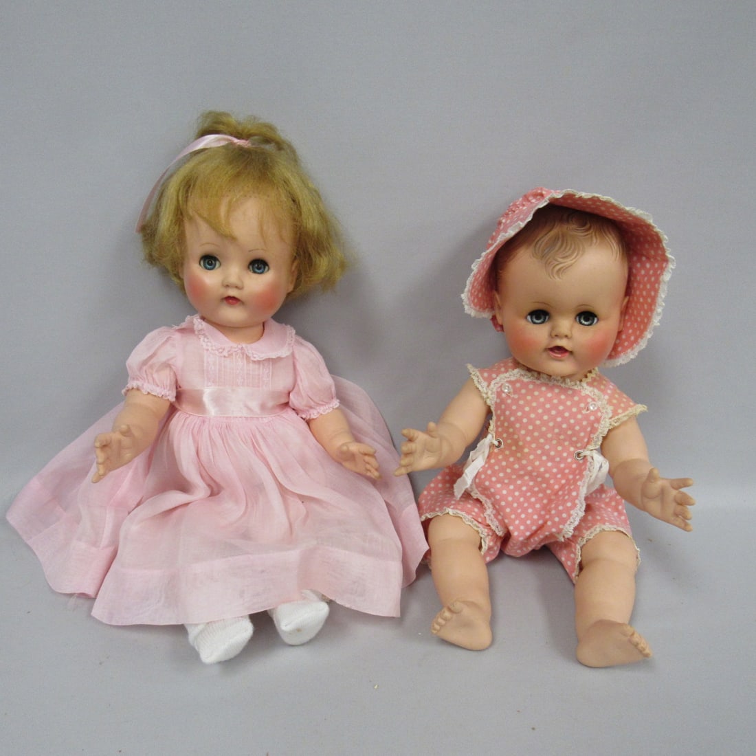 PAIR OF ALEXANDER BABY DOLLS:: 19 IN. "BONNIE" MARKED ALEXANDER CIRCA 1954, TAGGED DRESS, STUFFED VINYL, THIN HAIR ON BANG AREA. 8 PIECES OF CLOTHING INCLUDED. 15 IN. MARKED ALEXANDER "KATHY" BABY CIRCA 1956 ORIGINAL OUTFIT (NOT TA
