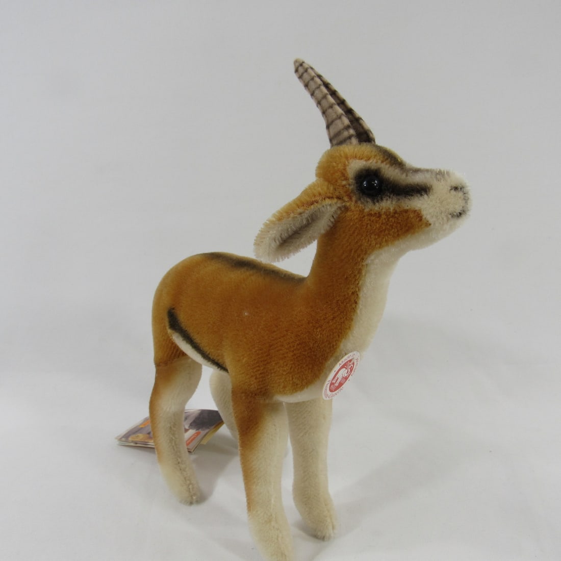 STEIFF 11 IN. H THOMSON - GAZELLE:: MOHAIR WITH CHEST TAG, BUTTON WITH EAR FLAG & ORIGINAL HANG TAGS