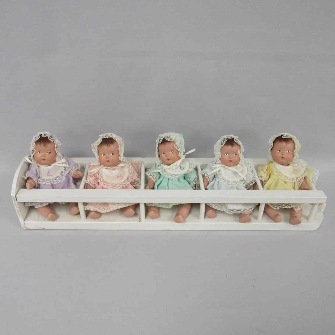 ALEXANDER DIONNE QUINTS IN CARRIER:: DOLLS HAVE BEEN REDRESSED, BODIES MARKED ALEXANDER