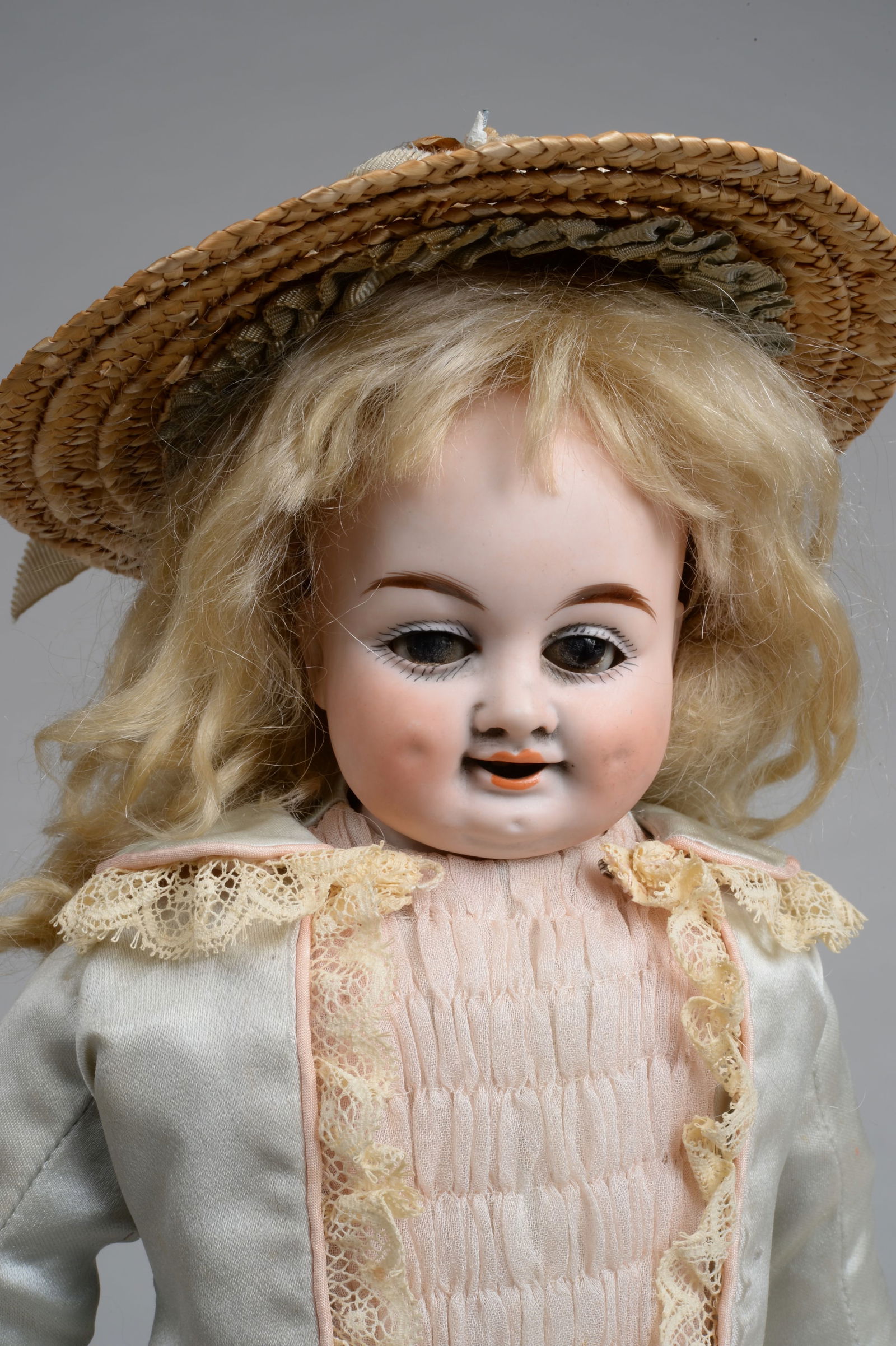 13 IN. SMILING DIMPLED GERMAN CHARACTER CHILD:: GERMANY, CIRCA 1900, POSSIBLY GEBRUDER KUHNLENZ, BISQUE SHOULDERHEAD WITH INDECIPHERABLE NUMBERS AT EDGE OF BACK SHOULDER PLATE, WONDERFULLY MOLDED & PAINTED FEATURES WITH BROWN GLASS SLEEPING EYES, D