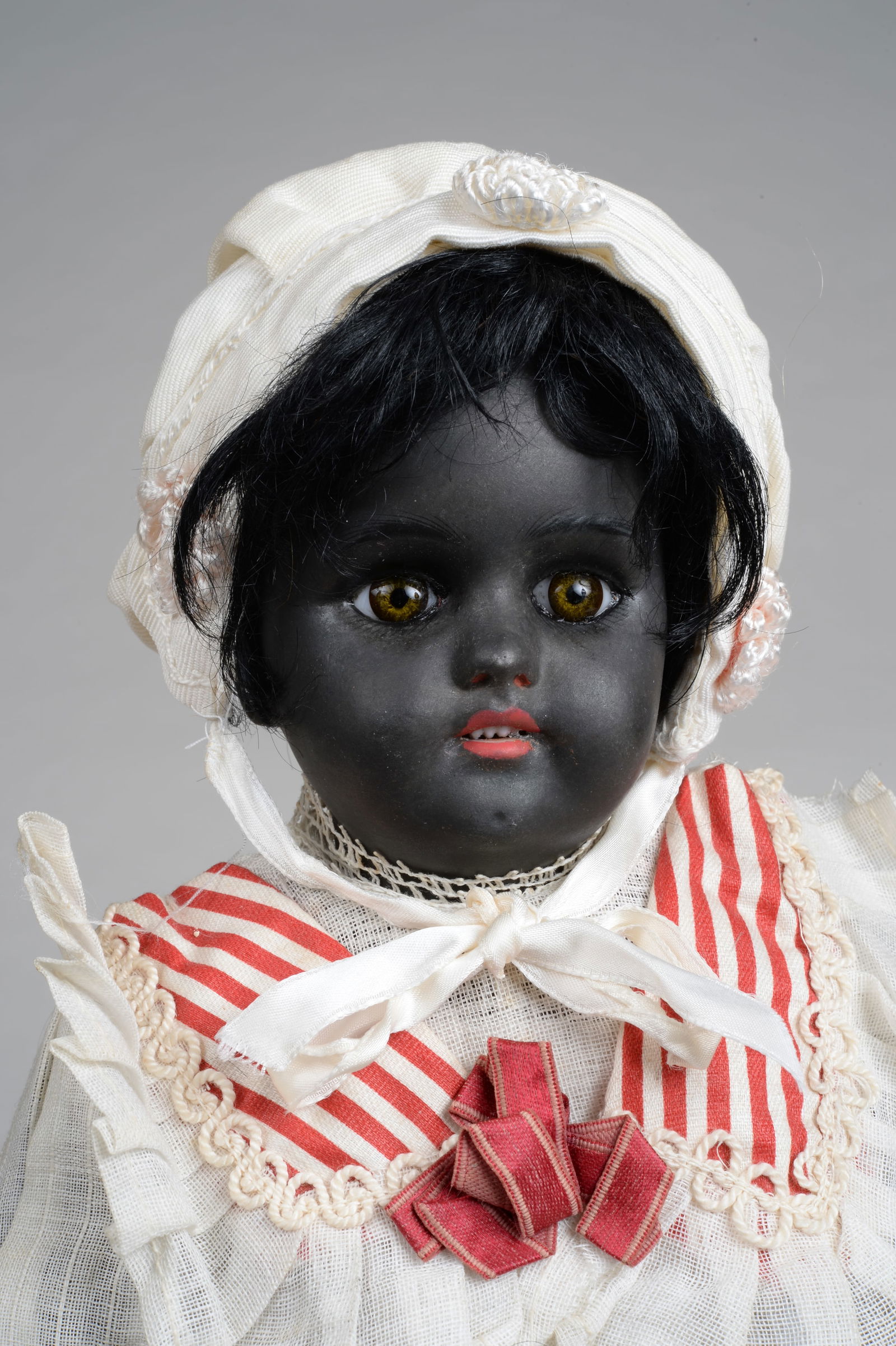 14.5 IN. SIMON HALBIG 1079 BLACK CHILD:: SIMON HALBIG, GERMANY, CIRCA 1900, BLACK BISQUE SOCKET HEAD INCISED 1079 GERMANY SIMON HALBIG S & H 6, WITH MOLDED & PAINTED FEATURES, GERMAN PAPERWEIGHT EYES, OPEN MOUTH WITH FOUR BISQUE TEETH, PIERC