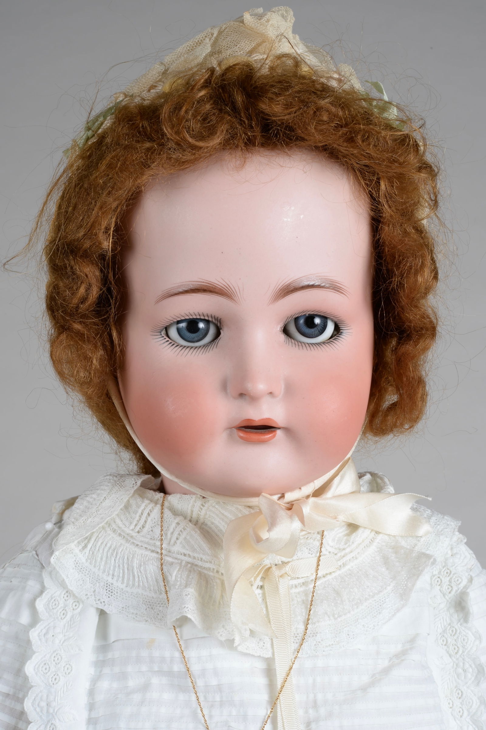 29 IN. KAMMER & REINHARDT WALKING CHILD DOLL:: WALTERHAUSEN, GERMANY, CIRCA 1900, BISQUE SOCKET HEAD INCISED K (STAR) R SIMON HALBIG 76, MOLDED & PAINTED FEATURES WITH BLUE SLEEP EYES, FULL BLUSHED CHEEKS, OPEN MOUTH FOUR PORCELAIN TEETH, FINE QUA