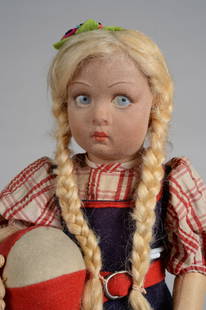 14.5 IN. LENCI CHILD W/ BALL ALL ORIGINAL WITH TAG: ITALY, CIRCA 1935, FELT SWIVEL HEAD, ON A COTTON TEXTURED BODY JOINTED AT SHOULDERS HIPS, ORIGINAL BLUE FELT DRESS WITH ORIGINAL LENCI TAG, RED PLAID BLOUSE, BLONDE BRAIDS, HOLDING RED & WHITE FELT BA
