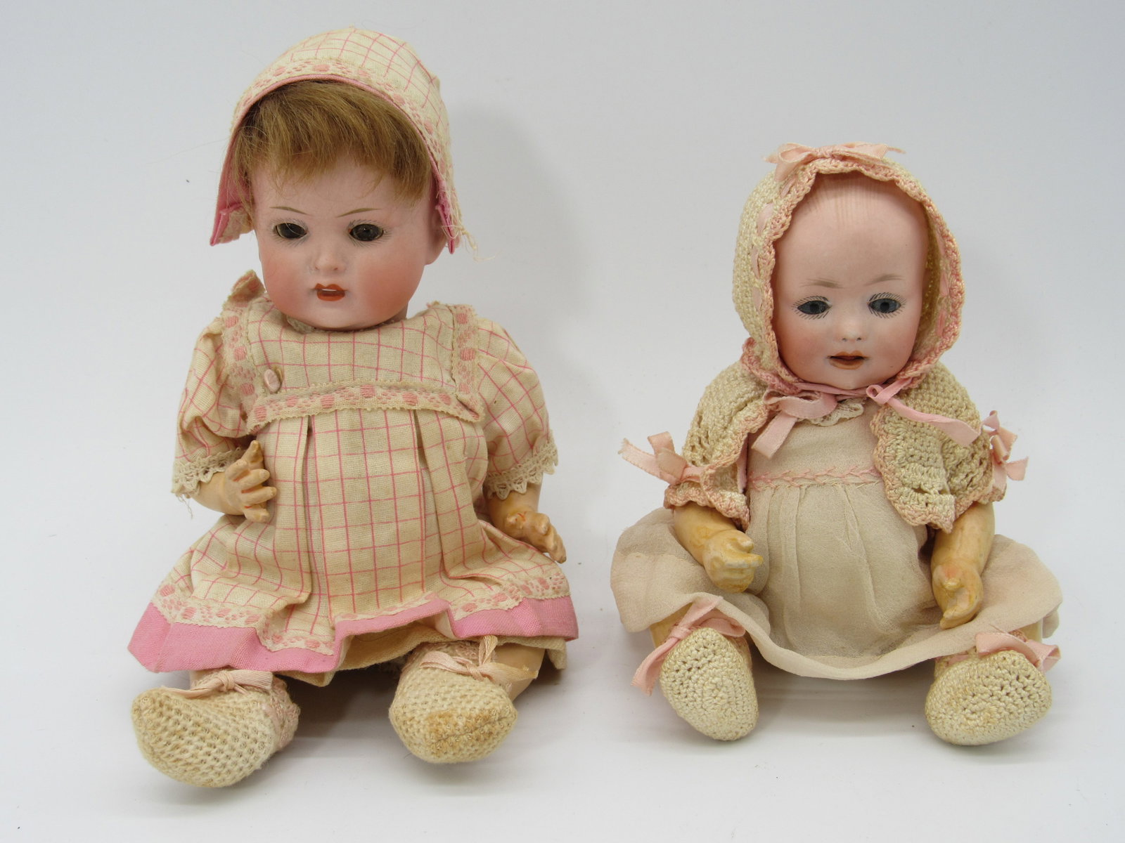 PAIR OF SMALL BISQUE HEAD BABIES:: INCLUDES 7 IN. BISQUE DOME SOCKET HEAD, SET EYES, FLAKE ON RIGHT EYE, OPEN MOUTH SHOWING TONGUE, 5 PIECE COMPO BODY, OUTFIT PERIOD MAY BE ORIGINAL, MARKED GERMANY 326 - AN ARMAND MARSEILLE MARK. 9 IN.