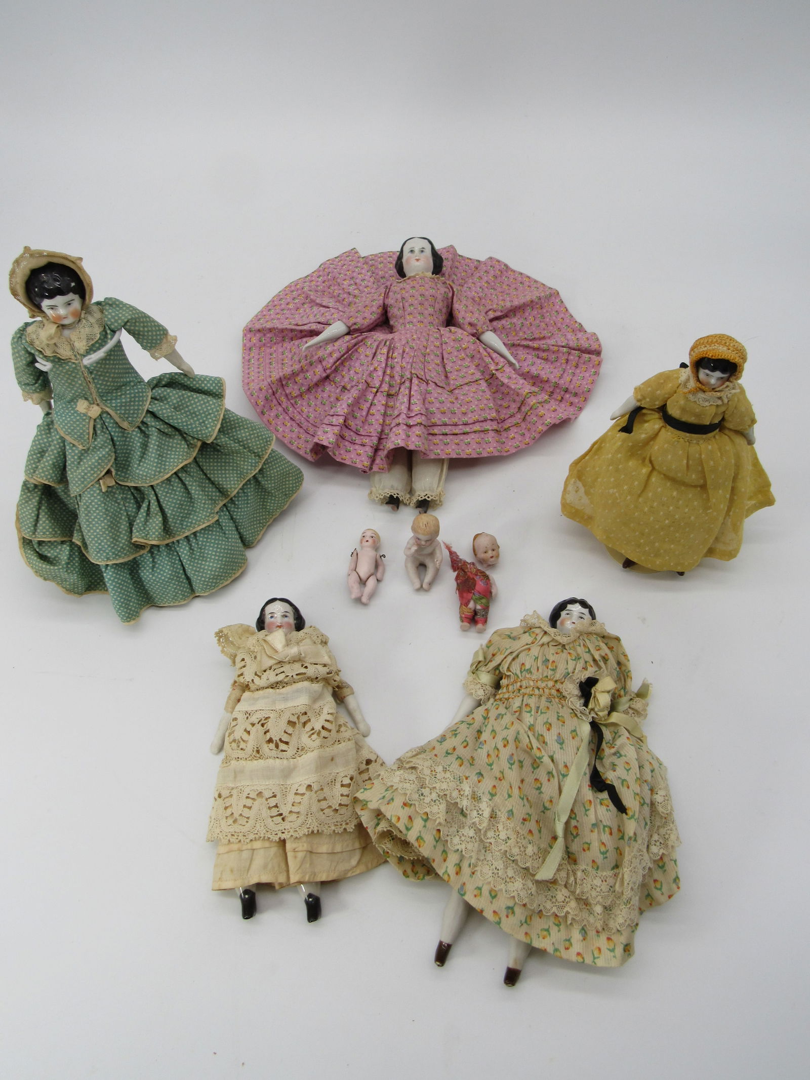 2 BOX LOT CHINA & ALL BISQUE DOLLS:: INCLUDES (5) CHINAS RANGE IN SIZE FROM 6 IN. TO 8 IN., ALL BUT LARGEST ONE HAVE SEWN ON CLOTHING, ALL HAVE CLOTH BODIES & CHINA LIMBS WITH NO DAMAGE. 3 SMALL ALL BISQUE, PIANO BABY, 2 IN. JOINTED & 2