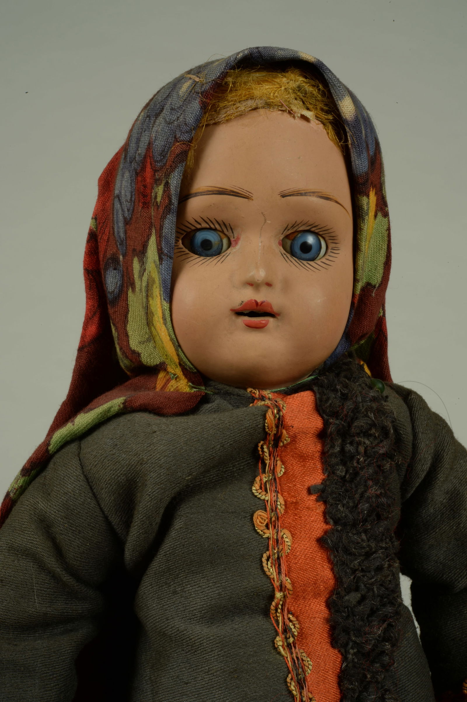 15.5 IN. ALL ORIG. RUSSIAN GIRL DOLL:: IN ELABORATE AUTHENTIC COSTUME. RUSSIA, CIRCA 1915, FINE QUALITY TERRA COTTA SOCKET HEAD WITH GLASS SLEEPING EYES, WITH MOLDED & PAINTED FEATURES &AN OPEN MOUTH, ORIGINAL GOLDEN FLAX WIG, ON HER