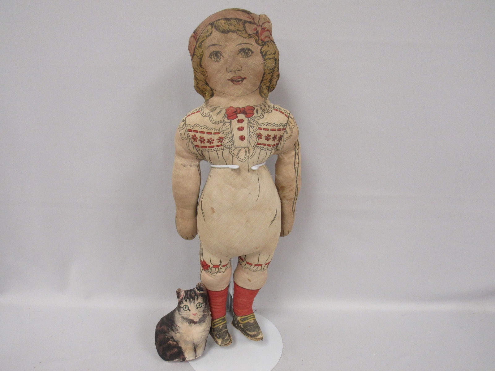 2 PCS. - PRINTED CLOTH DOLL & CAT:: 23 IN. FULL FIGURE YOUNG GIRL (CIRCA LATE 1880?S) IN PRINTED OUTFIT, SHOES, ETC., SHOWS WEAR & SEWING REPAIRS IN AREA. 6 ? IN. H CAT IN SITTING POSITION