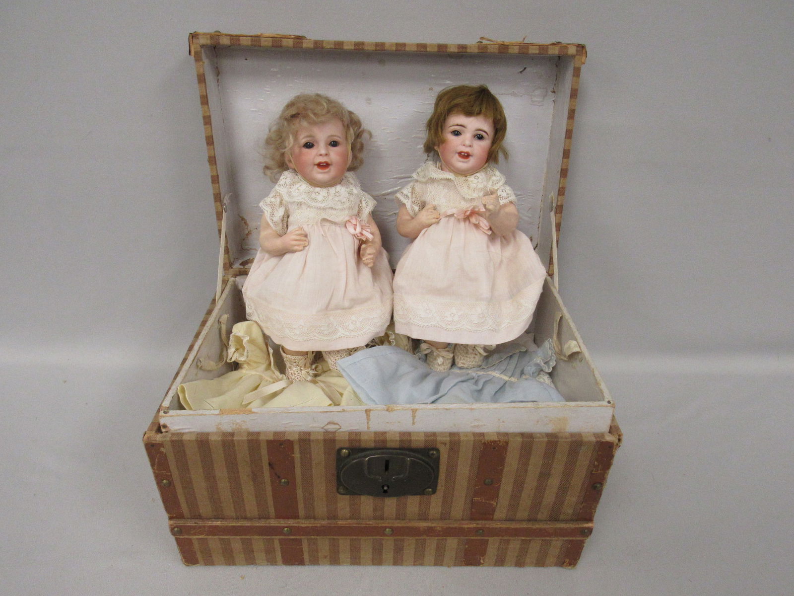 PAIR OF SFBJ LAUGHING JUMEAU TWINS:: MARKED SFBJ 236 PARIS. BISQUE SOCK HEADS, BROWN HAIR HAS HAIRLINES THAT ARE ONLY VISIBLE WHEN VIEWED WITH BRIGHT LIGHT INSIDE OF FOREHEAD FROM MID-RIM TOWARD EACH EYEBROW. BLONDE IS PERFECT, 