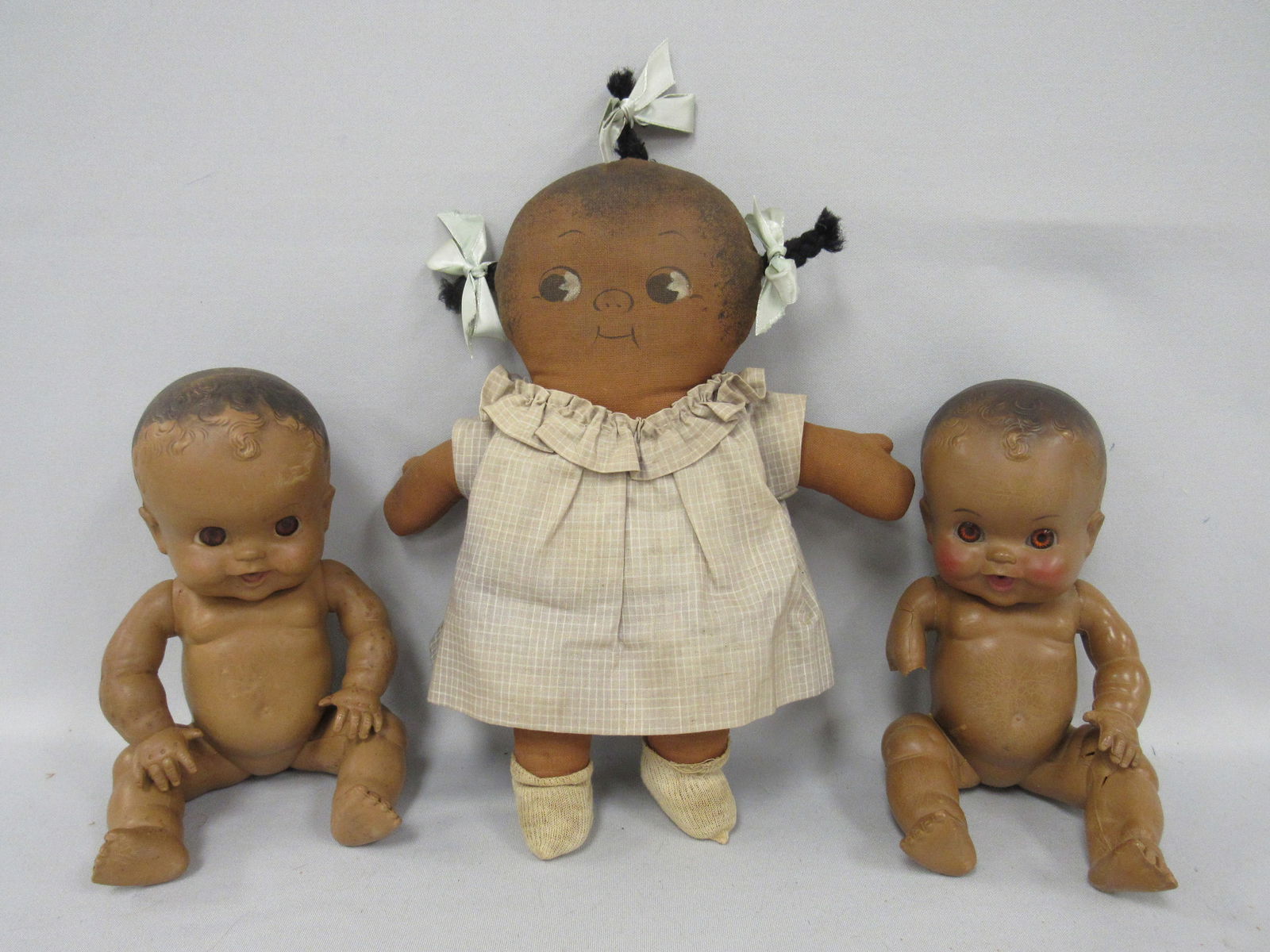 3 BLACK DOLLS:: INCLUDES "CHOCOLATE DROP" BY GRACE G. DRAYTON (ALSO DID DOLLY DINGLE & CAMPBELL KIDS) ORIGINAL DRESS IS FADED. 11 IN. - (2) - 10 IN. "AMOSANDR'S" BY SUN RUBBER FROM AMOS & ANDY RADIO SHOW 1940'S. 
