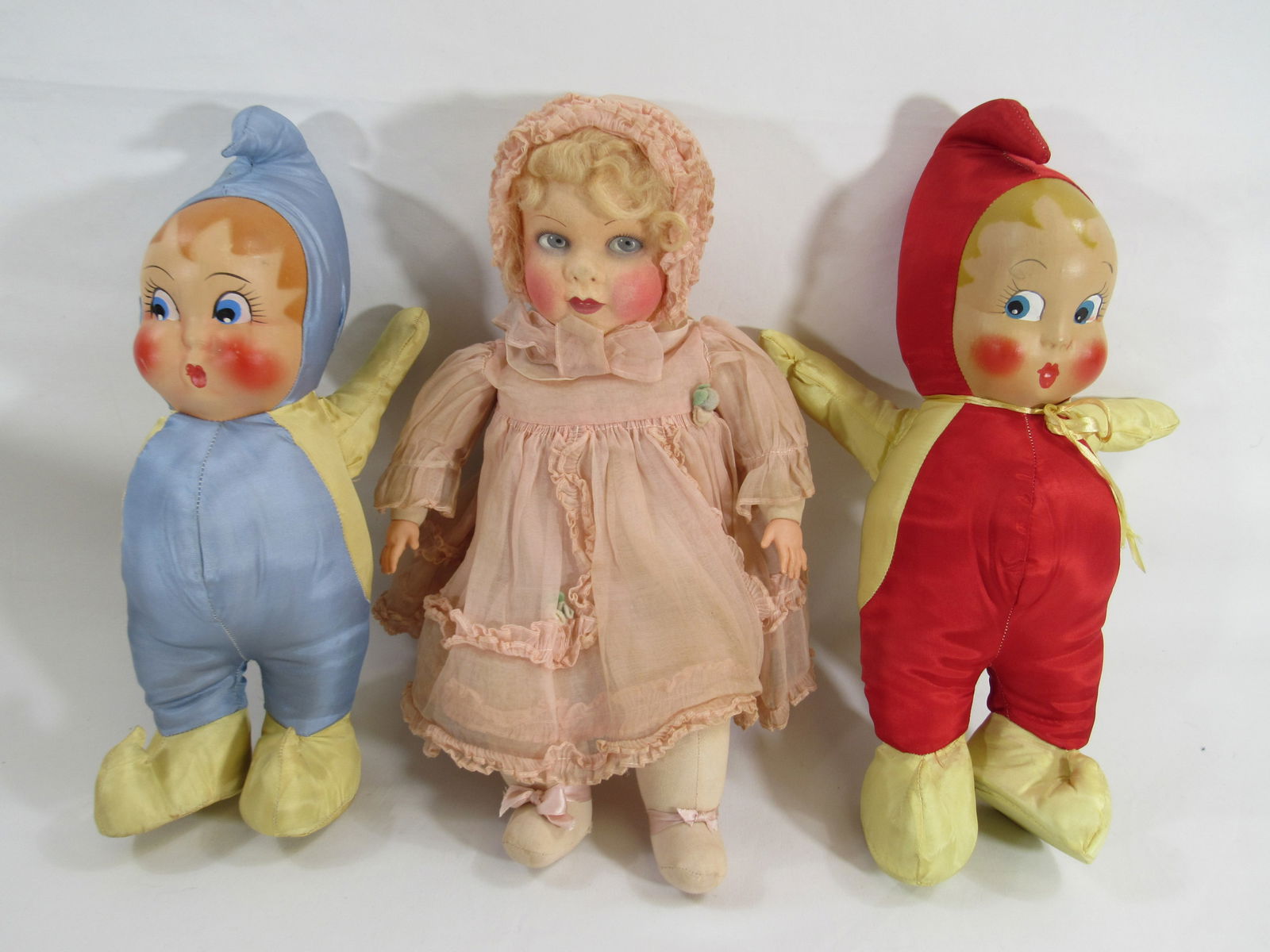 3 FUN DOLLS:: 16 IN. MASK FACE BABY WITH CLOTH BODY & CELLULOID HANDS, MINT CRISPY OUTFIT, SMALL NOSE RUB, POSSIBLY RAYNAL. 2 SATIN CARNIVAL FAVORS, ONE BLUE, OTHER RED, BLUE HAS SCRATCHES ON FACE 14 IN. - G