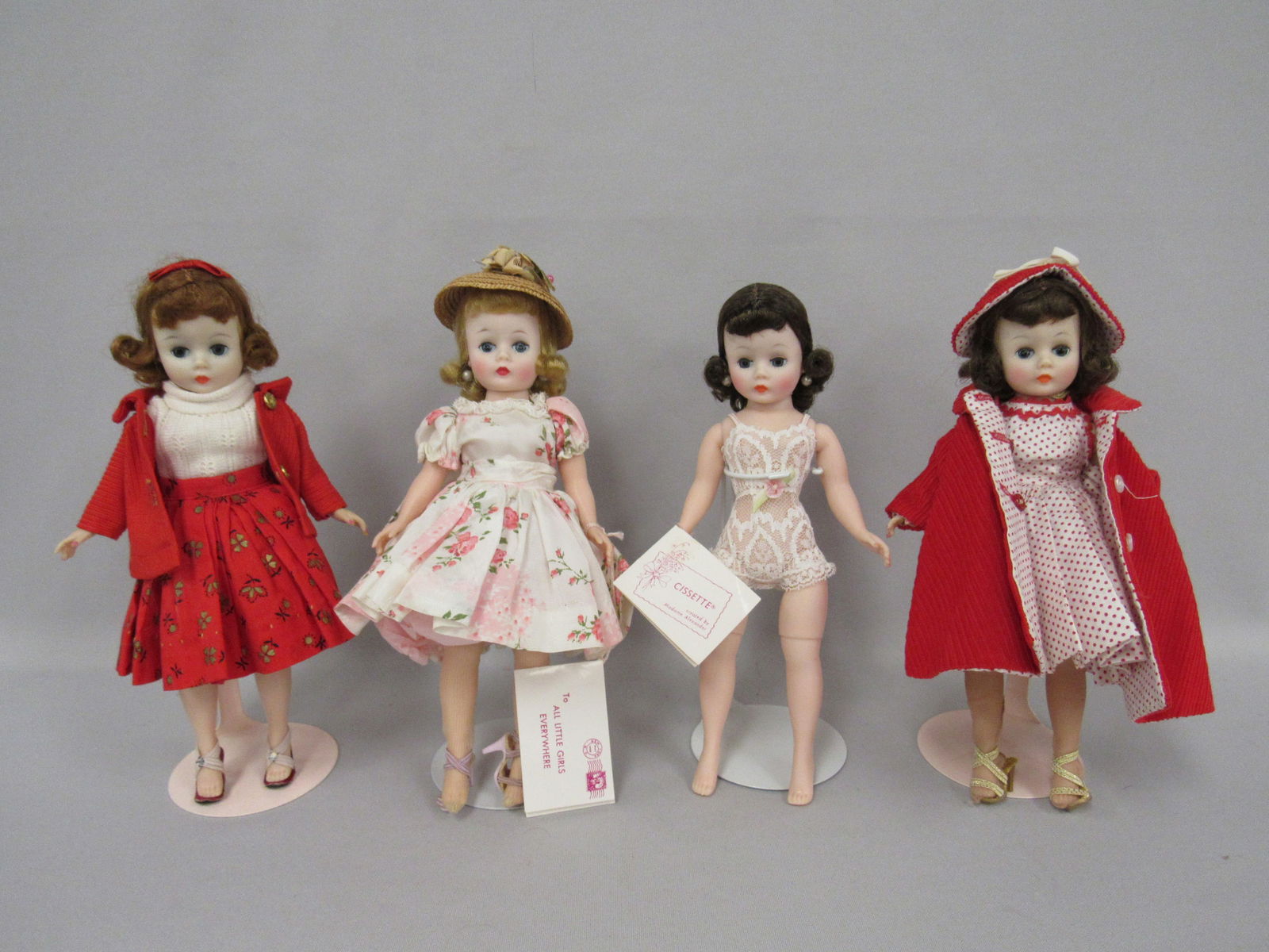 4 ALEXANDER "CISSETTE" LOT:: INCLUDES REVERSE HAT, COAT SET, PINK FLORAL & HAT SET WITH HANG TAG, CHEMISE WITH TAG & JACKET & SKIRT SET. ALL DOLLS ARE CLEAN, 3 WITH VERY GOOD COLOR - G/VG
