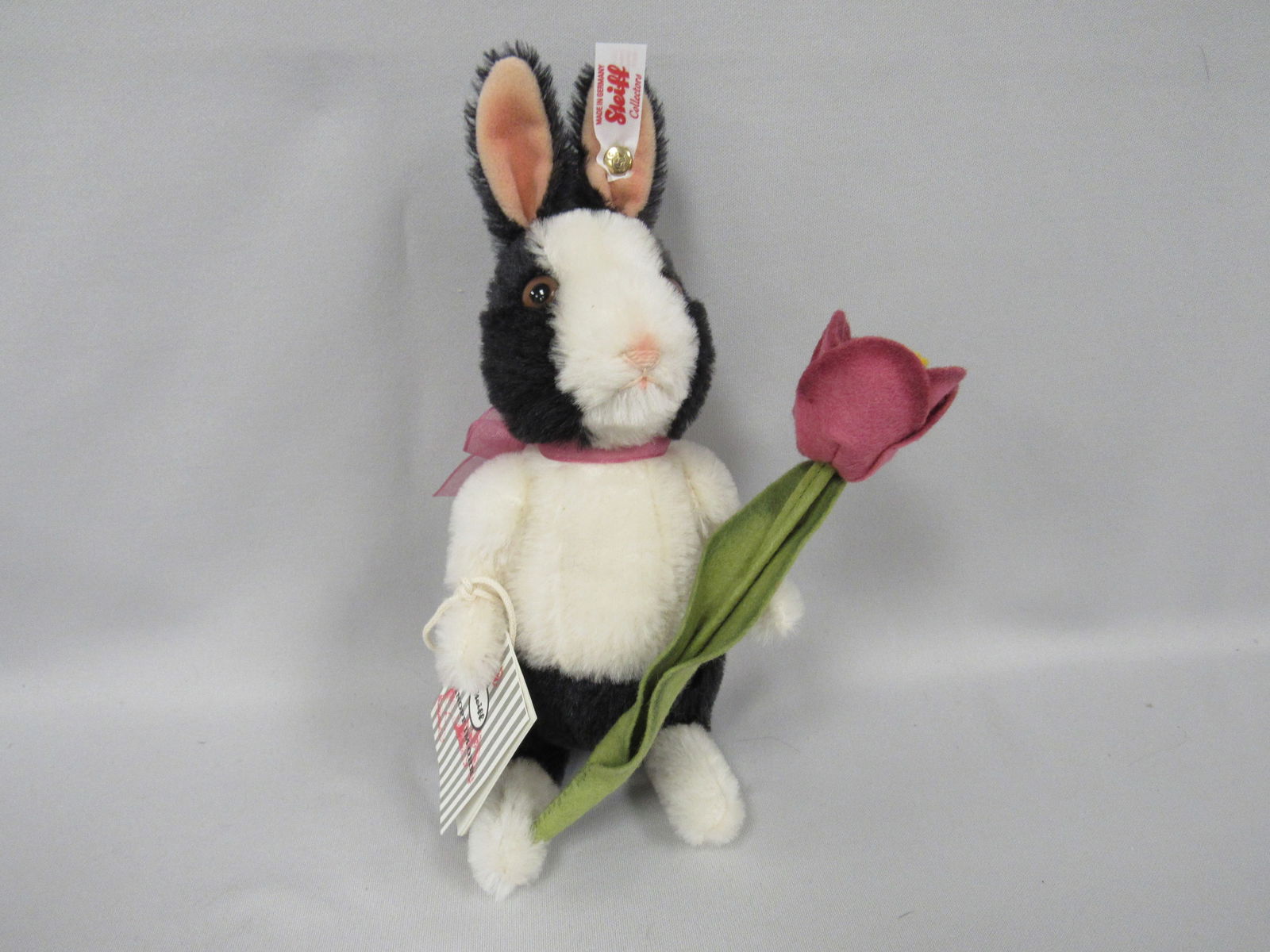 STEIFF 10 IN. H "PEPPER" SPRINGTIME BUNNY:: LIM. EDITION MOHAIR & COTTON BUNNY HOLDING A PINK FELT TULIP #74/750 WITH C.O.A., BUTTON & EAR TAG & HANG TAG - VERY CLEAN & LIKE NEW! COMES WITH A STEIFF BOX WITH PRINTED TEDDY BEAR DECOR.