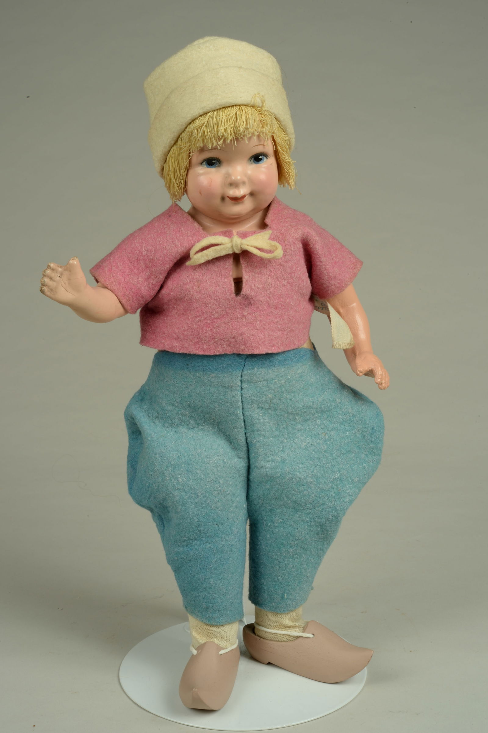 ALL ORIGINAL 15 IN. GRACE COREY DUTCH CHAR. CHILD:: AMERICA, CIRCA 1935, COMPOSITION SHOULDER HEAD EMBOSSED GRACE CORRY, MOLDED & PAINTED FEATURES, SWEET CHARACTER FACE WITH SMILING MOUTHS ON CLOTH BODY WITH COMPOSITION ARMS, WEARING FELT DUTCH OUTFIT