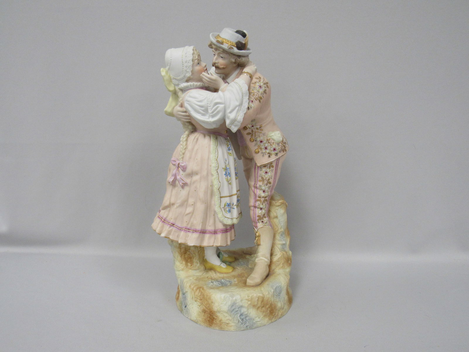 WONDERFUL 17 IN. H FIGURINE OF YOUNG COUPLE:: A.K.A. "COURTING COUPLE" BEAUTIFULLY DETAILED & COLORFUL BISQUE FIGURINE OF A YOUNG MAN EMBRACING A YOUNG LADY AS HE ATTEMPTS TO KISS HER. THE MODELING & DECORATION OF THIS LARGE FIGURE IS IMPRESSIVE