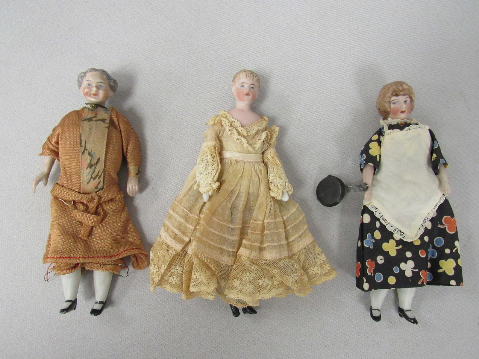 3 GERMAN 6 IN. DOLL HOUSE DOLLS:: BISQUE SHOULDER PLATES CLOTH BODIES, BISQUE LIMBS, SEWN ON CLOTHING, INCLUDES A COOK MATURE WOMAN, LACE DRESSED YOUNG WOMAN IN LACE DRESS (NOT SEWN ON) - G