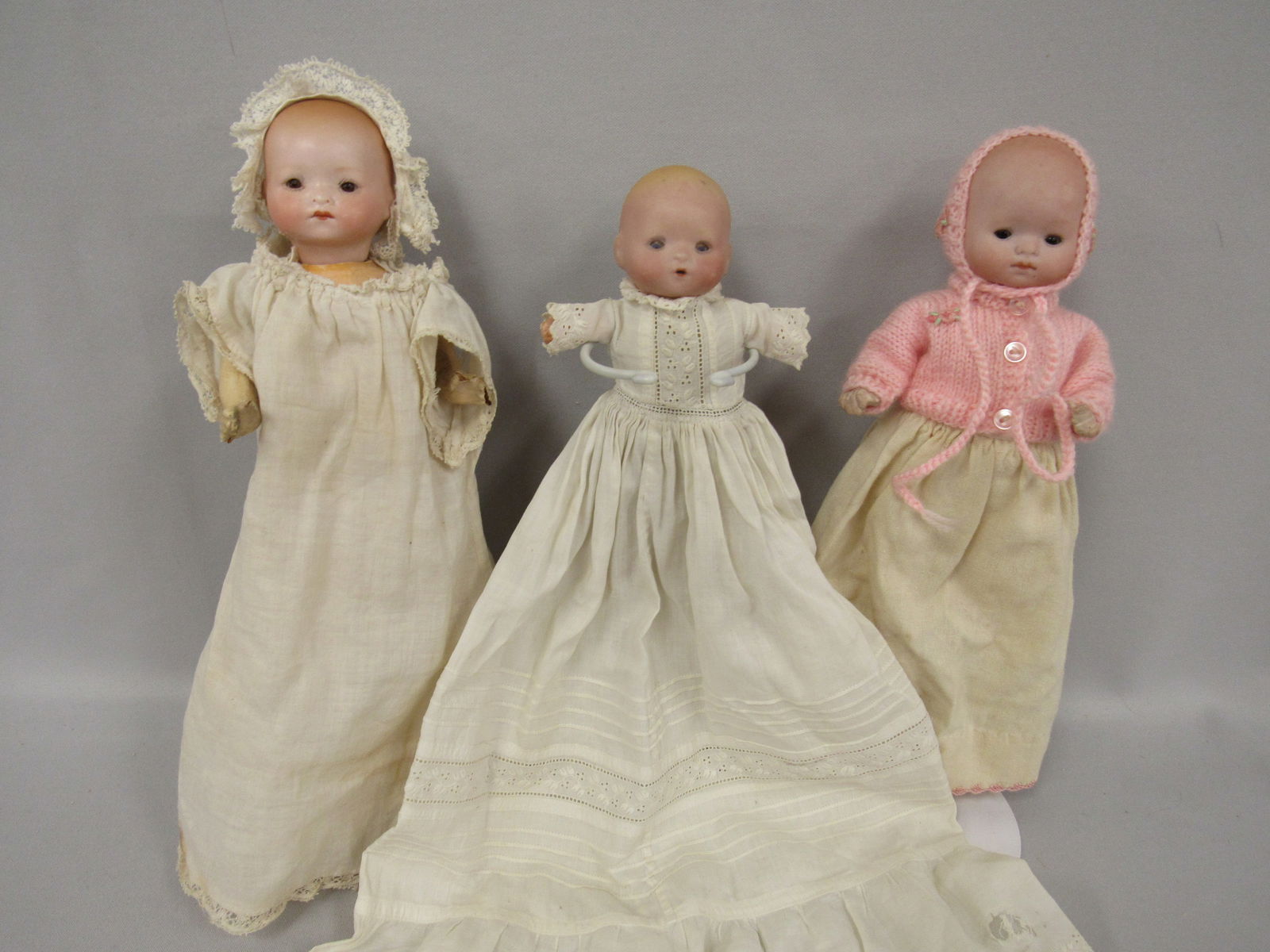 TRIO OF BISQUE HEAD BABIES:: INCLUDES 8 IN. DREAM BABY, MARKED GERMANY 1924 161 (NO VISIBLE DAMAGE), SLEEP EYES, COMPO BODY, 5 IN. OPEN MOUTH, SLEEP EYES, NO VISIBLE DAMAGE, COMPO ARMS CLOTH BODY. 8 IN. MARKED AM GERMANY 349 NO