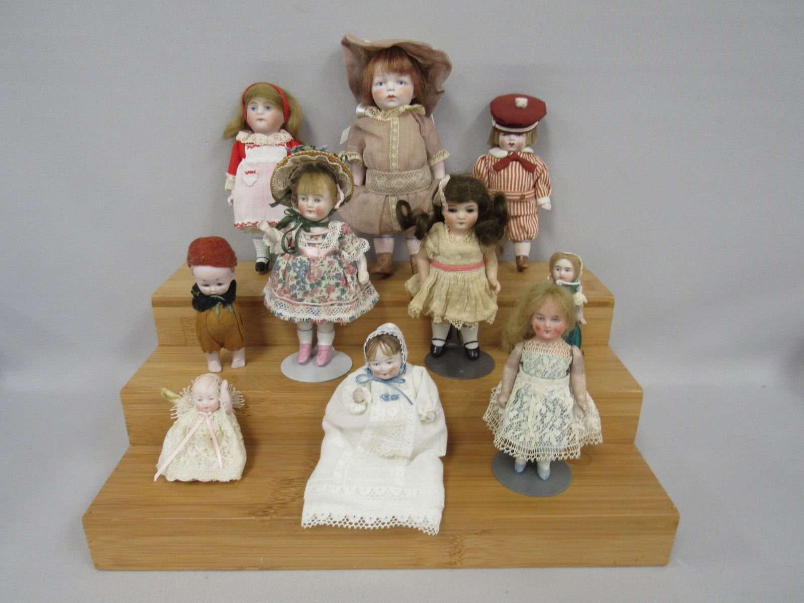 10 PCS. OF SMALL ALL BISQUE DOLLS:: SIZES RANGE FROM 2.5 IN. TO 6 IN., SOME HAVE FIXED LEGS, OTHERS ARE MOVABLE. ALL ARE VERY NICELY DRESSED. - VG