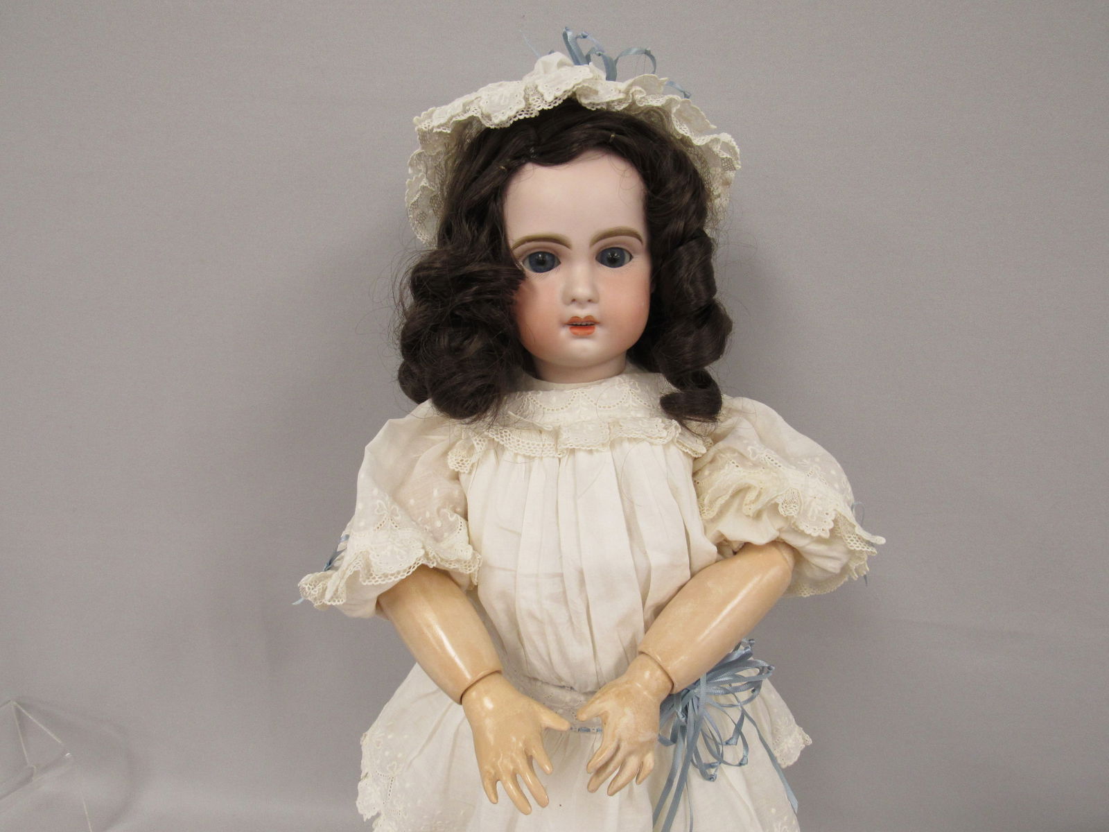 23 IN. JUMEAU HEAD DOLL:: SOCKETHEAD HAS A RIM CHIP & HAIRLINE (STABALIZED) ON THE RIGHT SIDE, SMALL LEFT CHEEK SCUFF, SLEEP EYES, OPEN MOUTH WITH TEETH. MARKED 8 ON BACK OF HEAD. REPLACED BODY AT SOME TIME - G