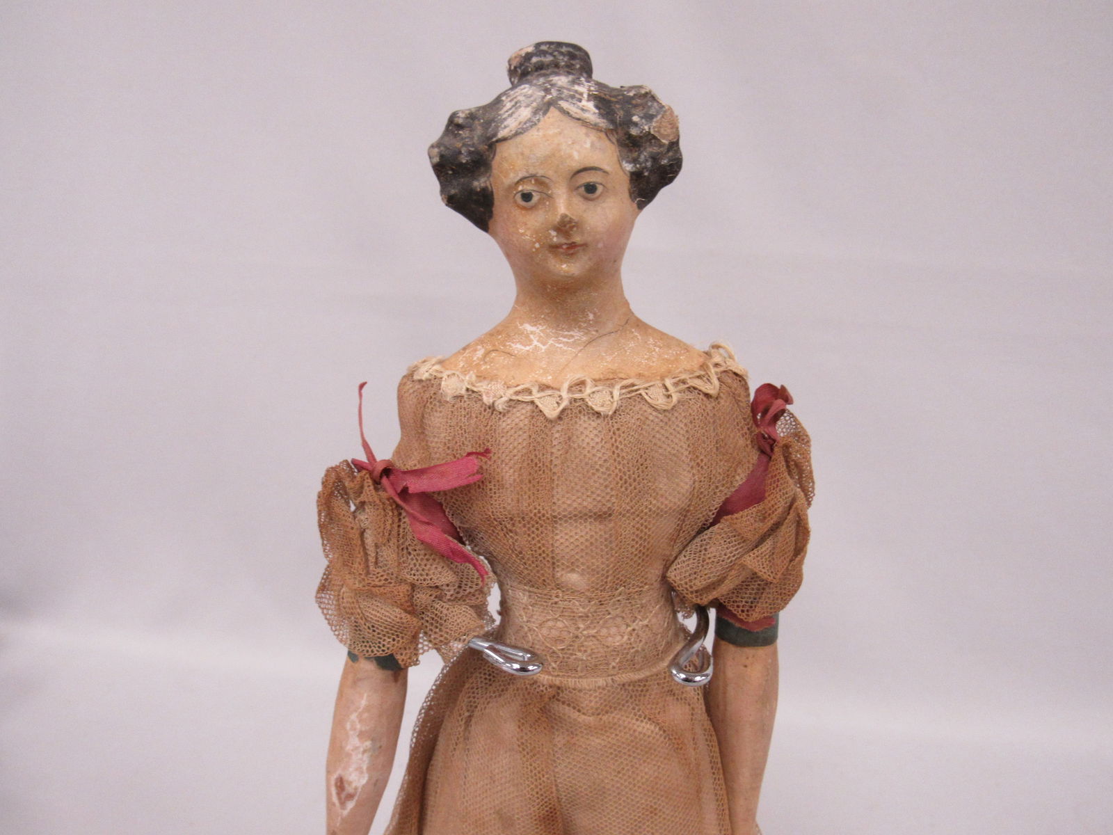 13 IN. MILLNERS MODEL:: KID BODY, PAPER MACHE SHOULDERPLATE (CRACK AROUND NECK) WOODEN ARMS & LEGS, LEGS HAVE REINFORCEMENT AROUND KNEES, ORIGINAL DRESS (FRAGILE), THERE ARE SOME SCUFFS TO NOSE & HAIR, BUT NO TOUCH-UPS -