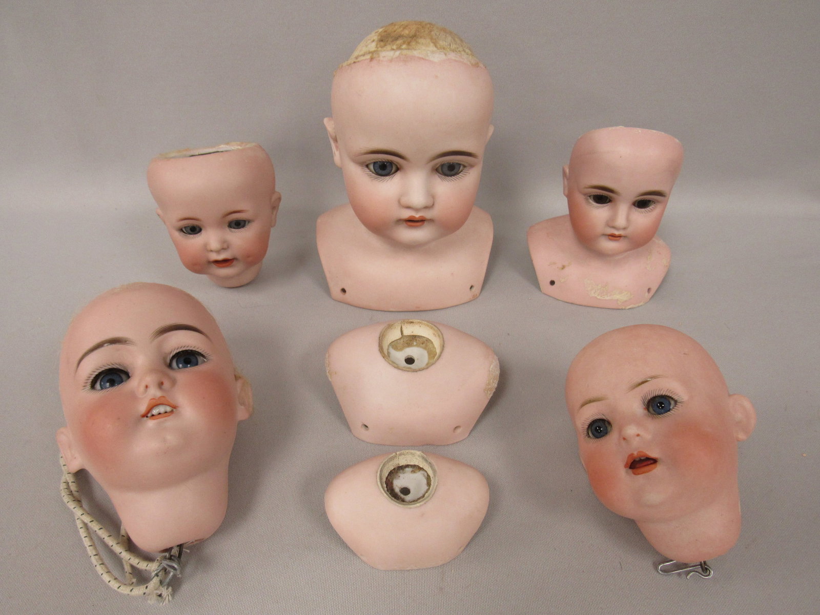 (5) BISQUE DOLL HEADS & (2) SHOULDER PLATES:: EACH IS FREE OF DAMAGE OR REPAIR & ARE USABLE