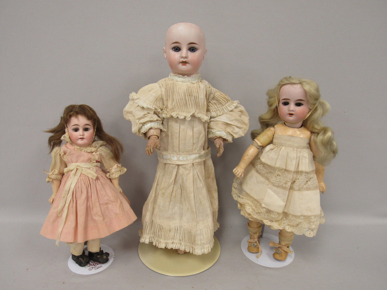 3 DOLL LOT:: INCLUDES 11.5 IN. MARKED 340 DEP BISQUE SOCKET HEAD, STATIONARY EYES, I.M. WITH TEETH, LIGHT SCUFF RIGHT CHEEK, COMPO BODY. STURDY COMPO WITH WEAR AT JOINTS. 15 IN. 1904 RECKNAGLE, BISQUE SOCKET HEAD,