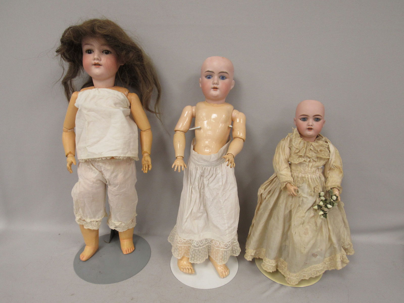 3 BISQUE HEAD DOLL GROUP:: INCLUDES BISQUE SOCKET HEAD MARKED ONLY 109.7 POSSIBLY KAMMER REINHART - NO DAMAGE - 16 IN. H, EYES ARE LOOSE, STURDY CLEAN COMPO BODY, ORIGINAL FINISH. 21 IN. BISQUE HEAD - NO DAMAGE - MARKED MADE IN