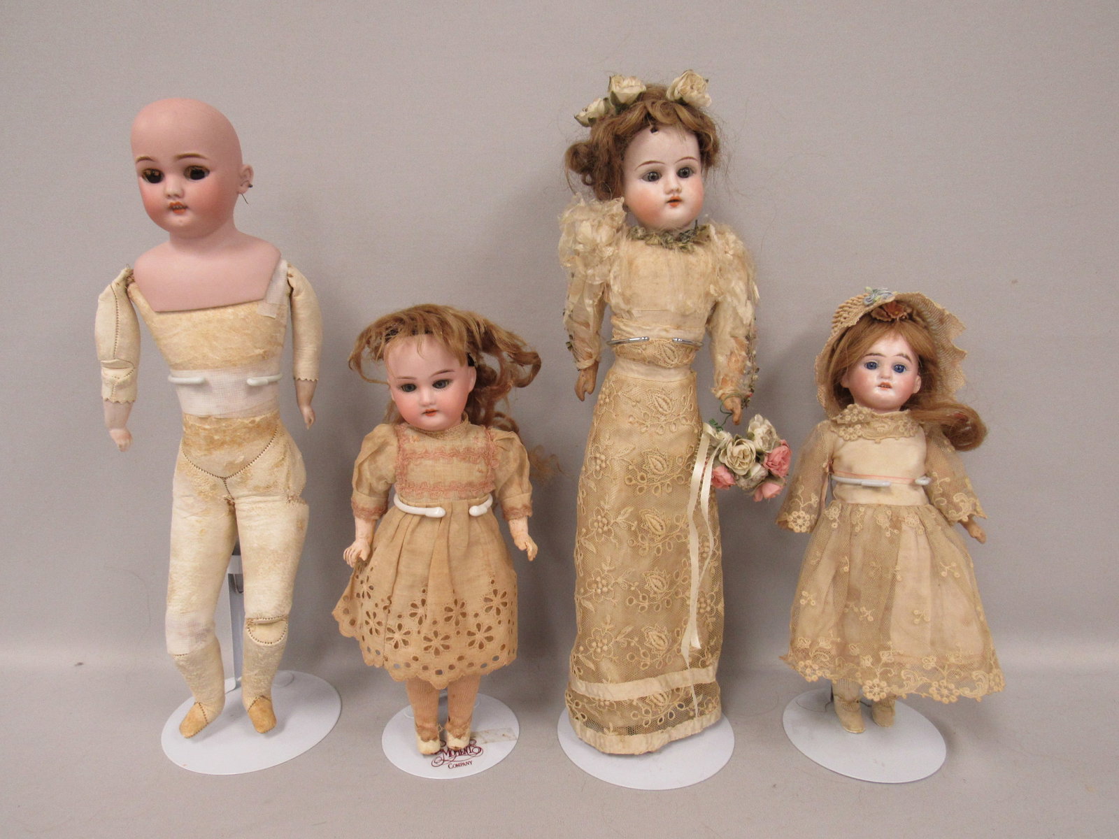 BISQUE HEAD DOLL GROUP:: INCLUDES 10.5 IN. SOCKET HEAD - NO DAMAGE - SLEEP EYES, O.M. WITH TEETH MARKED GERMANY C A7/0M, CRUDE 5 PIECE COMPO BODY, 11 IN. SOCKET HEAD, SMALL CHIP ON BOTTOM OF NECK OPENING, SET EYES, O.M. WITH