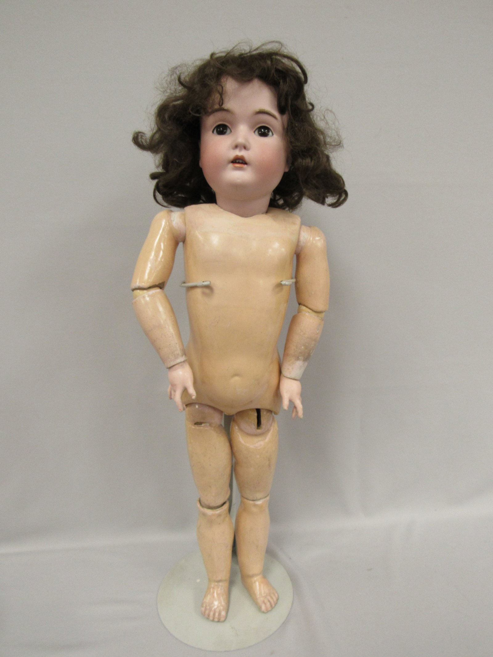 27 IN. KESTNER BISQUE SOCKET HEAD DOLL:: MARKED MADE IN GERMANY 171. SLEEP EYES, COUPLE OF SMALL WIG PULLS, BODY IS STAMPED IN RED - GERMANY 5 3/4. SEE PHOTO OF HER BACK. RE: LOSS OF COMPO & PAINT & AN UNKNOWN BULGE MARK FROM WITH THE BODY.