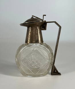 A Very Fine Imperial Russian Silver Mounted Carved Crystal Decanter - Circa 1910: Russian Empire, Moscow 1908-1916. Marked: "Lorie”, Fyodor firm Silver, translucent colorless crystal; faceting, casting, presswork, carving. Marks: "Lorie” alloy number "84”. 