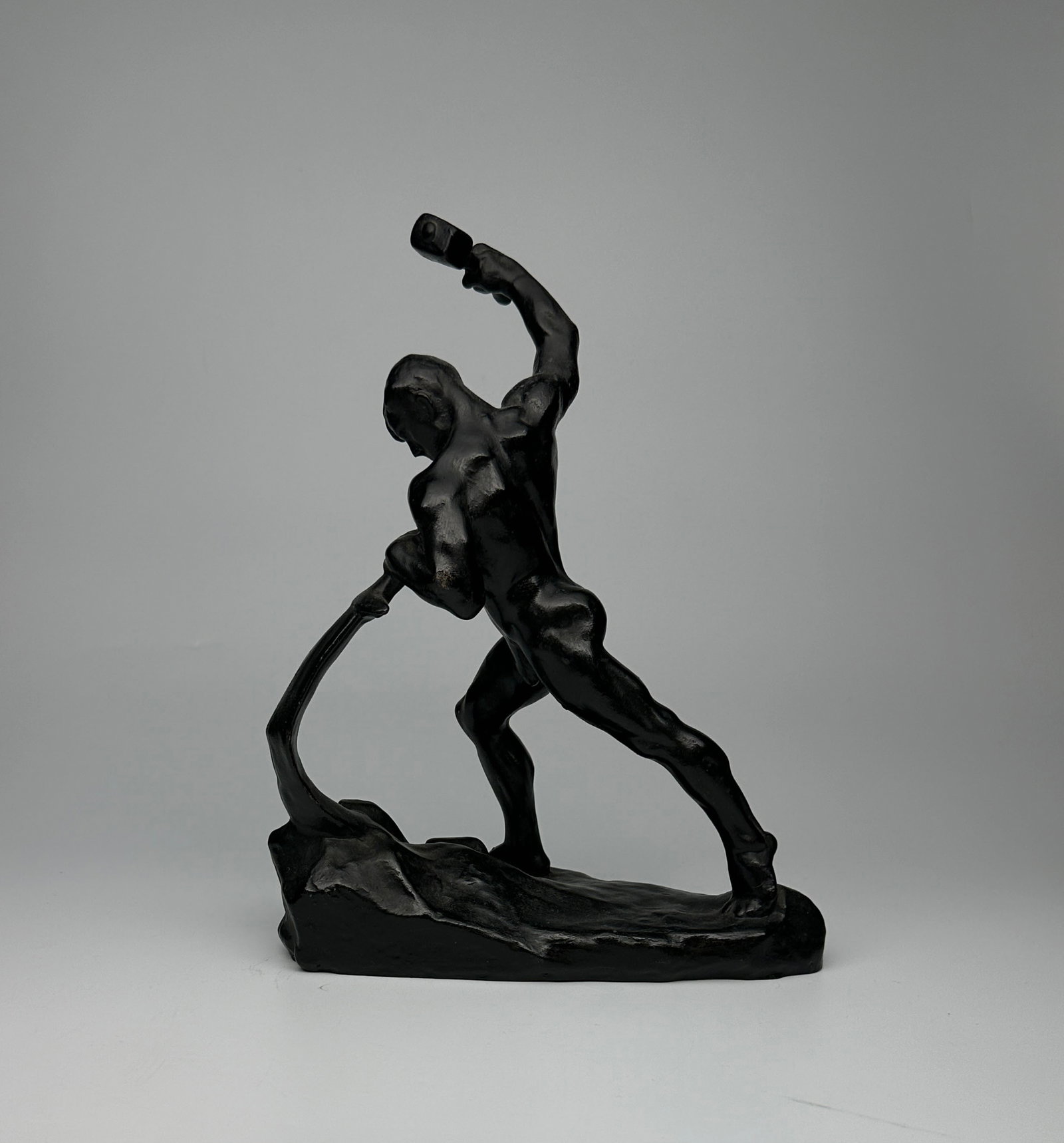 Sculpture "Swords into Ploughshares" Modernist 20th Century Soviet Russian Sculpture in Blackened: "Swords into Ploughshares" This handsome sculpture was realised in Russia in the 20th century. Created in blackened castiron, it features a male nude figure in the process of forging a sword into a pl