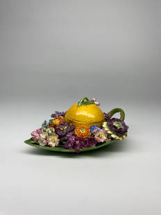 An exquisite Meissen inkwell / box in the shape of a lemon surrounded by a field of flowers - 19th: A lovely Meissen porcelain inkwell. Executed in a trompe loeil fashion the piece showcases the mastery of porcelain handling for Meissen. The inkwell is shaped as a lemon surrounded by vibrant flowers