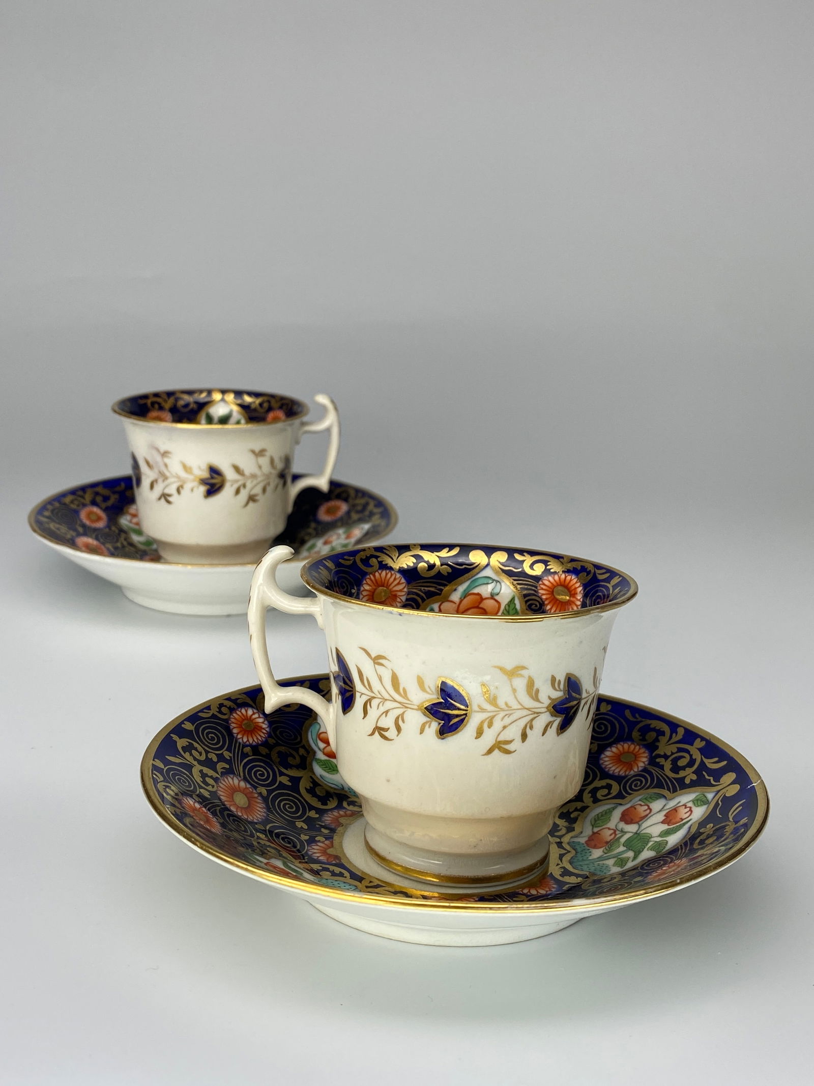 Pair of Royal Derby Tea Cup & Saucer Hand Painted in Cobalt Blue and Gold with Floral c1820s: Pair of Royal Derby Tea Cup & Saucer Hand Painted in Cobalt Blue and Gold with Floral Wonderful condition. This very nice pair of teacups and saucers are made of bone china porcelain by Royal Derby in