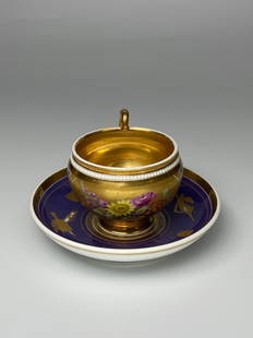 Imperial Russian Porcelain - Imperial Gilded Cup and Saucer - 1825: This is a rare and stunning example of fine Imperial Russian porcelain cup and saucer dating to 1825. The cup has a detailed handpainted floral bouquet at the center and is lavishly gilded on the inte