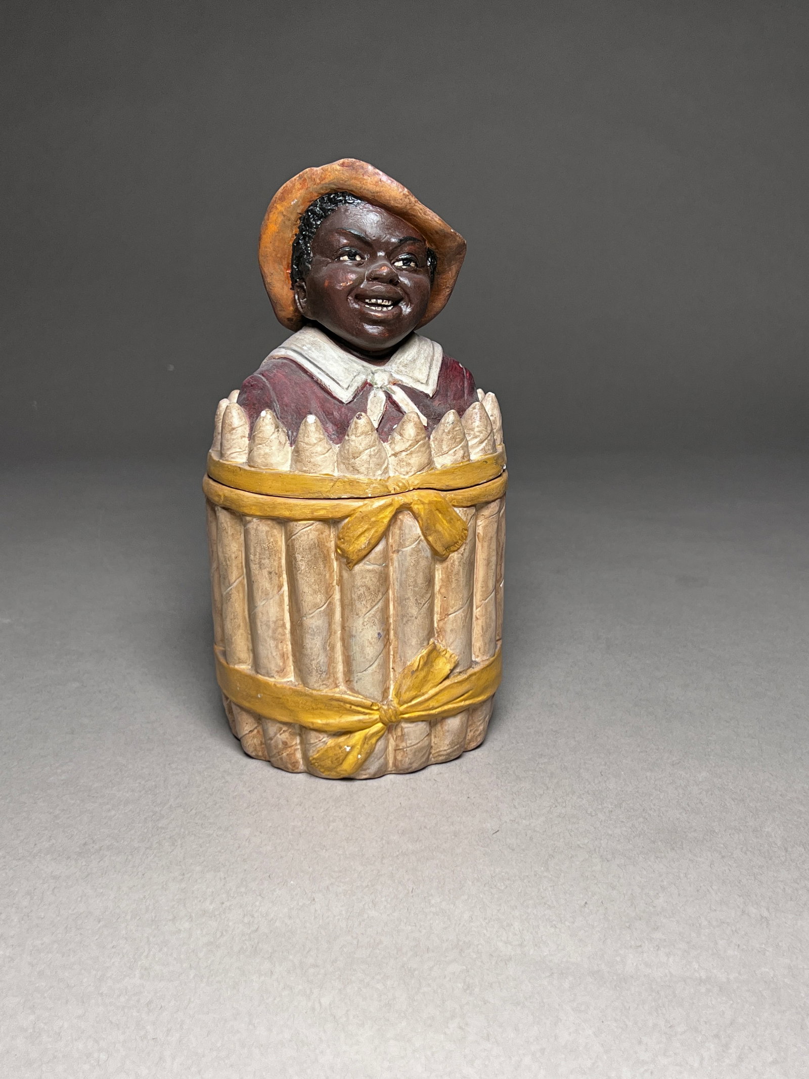 Americana Style Ceramic Humidor Tobacco Jar Depicting a Black Man Surrounded by Cigars: Antique Austrian Johann Maresch Humidor earthenware figural tobacco jar, depicting a black man that is surrounded by cigars. Earthenware Austria, Late 19th - Early 20th Century Height: 8.3" (21 cm)