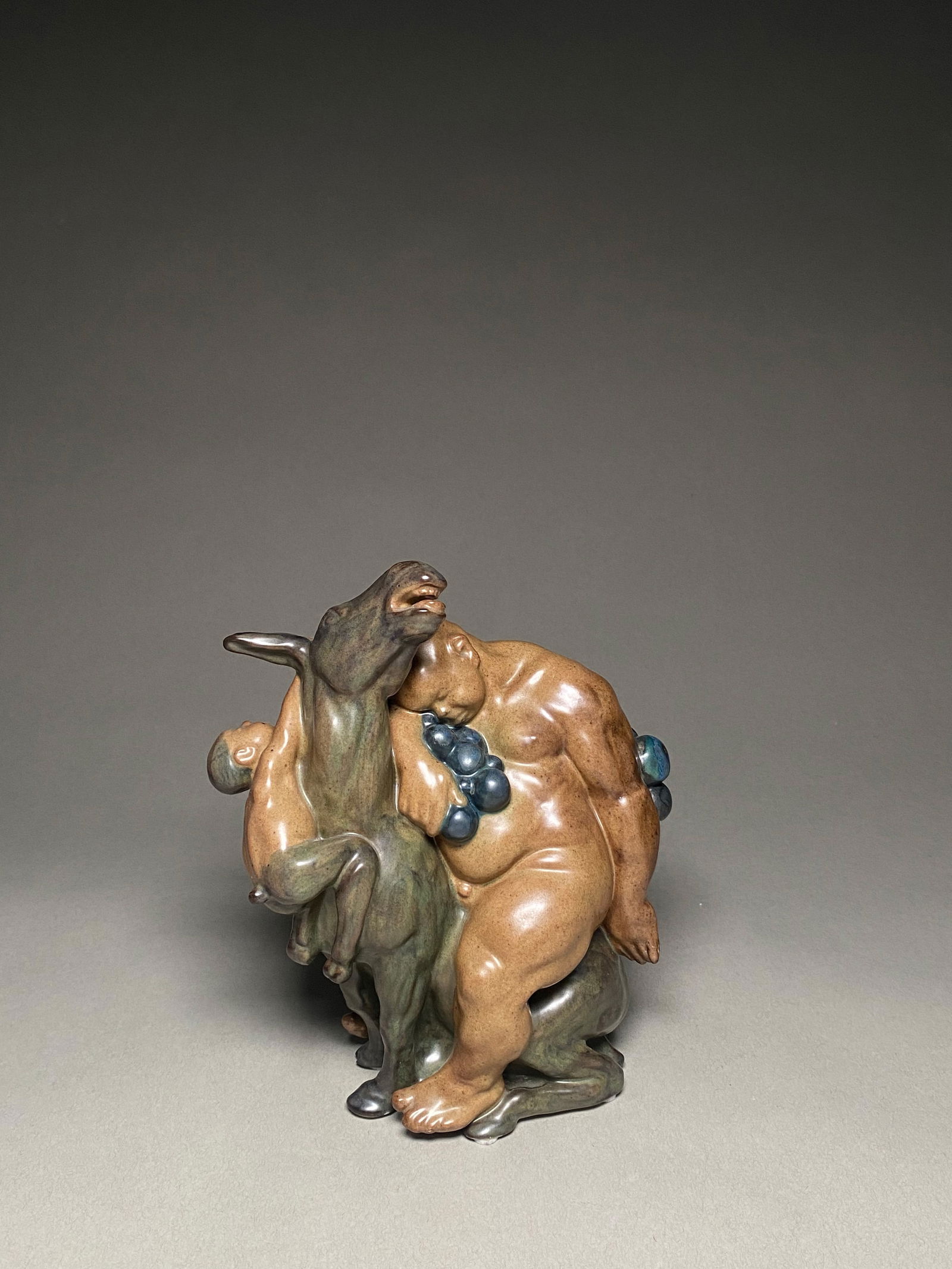 Kai Nielsen - Bing & Grondahl Stoneware Figure of Bacchus - 1920's: Stoneware figurine of Bacchus and a Faun by Kai Nielsen for Bing & Grondahl from the 1920's Bacchus series. A Kai Nielsen Bing & Grondahl stoneware figure is a captivating example of early 20th-centur