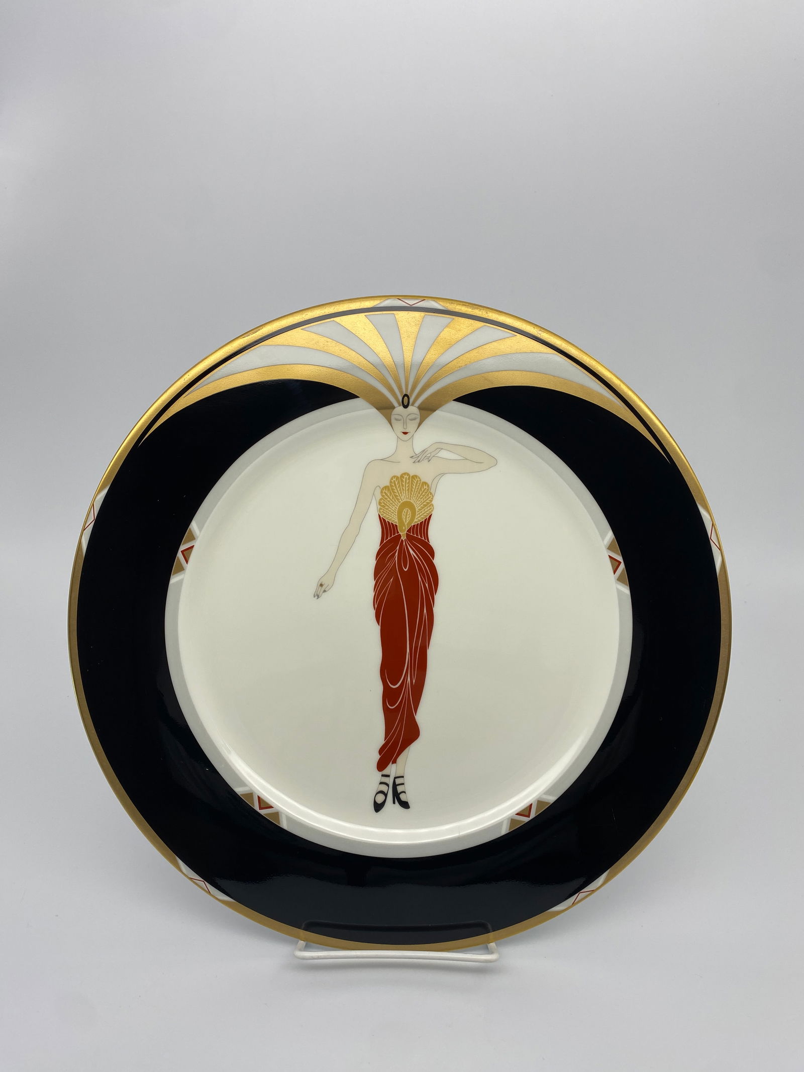 Erte Bone China "Le Soleil" ebony Border 1985 Charger Plate: 1985 Erte Le Soleil ebony a3049 Bone China Collectors Plate. Features a beautiful art deco model in maroon colored dress at center with wide black border and gold gilt details. Fantastic condition, no