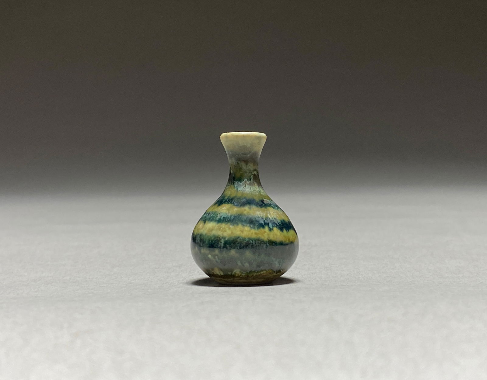 Petite Vase in the style of Carl Harry Stalhane, 1960s: Petite Vase in the style of Carl Harry Stalhane, 1960s This diminutive vase brilliantly captures the aesthetic sensibility of mid-century Scandinavian ceramics, particularly echoing the glazing techni