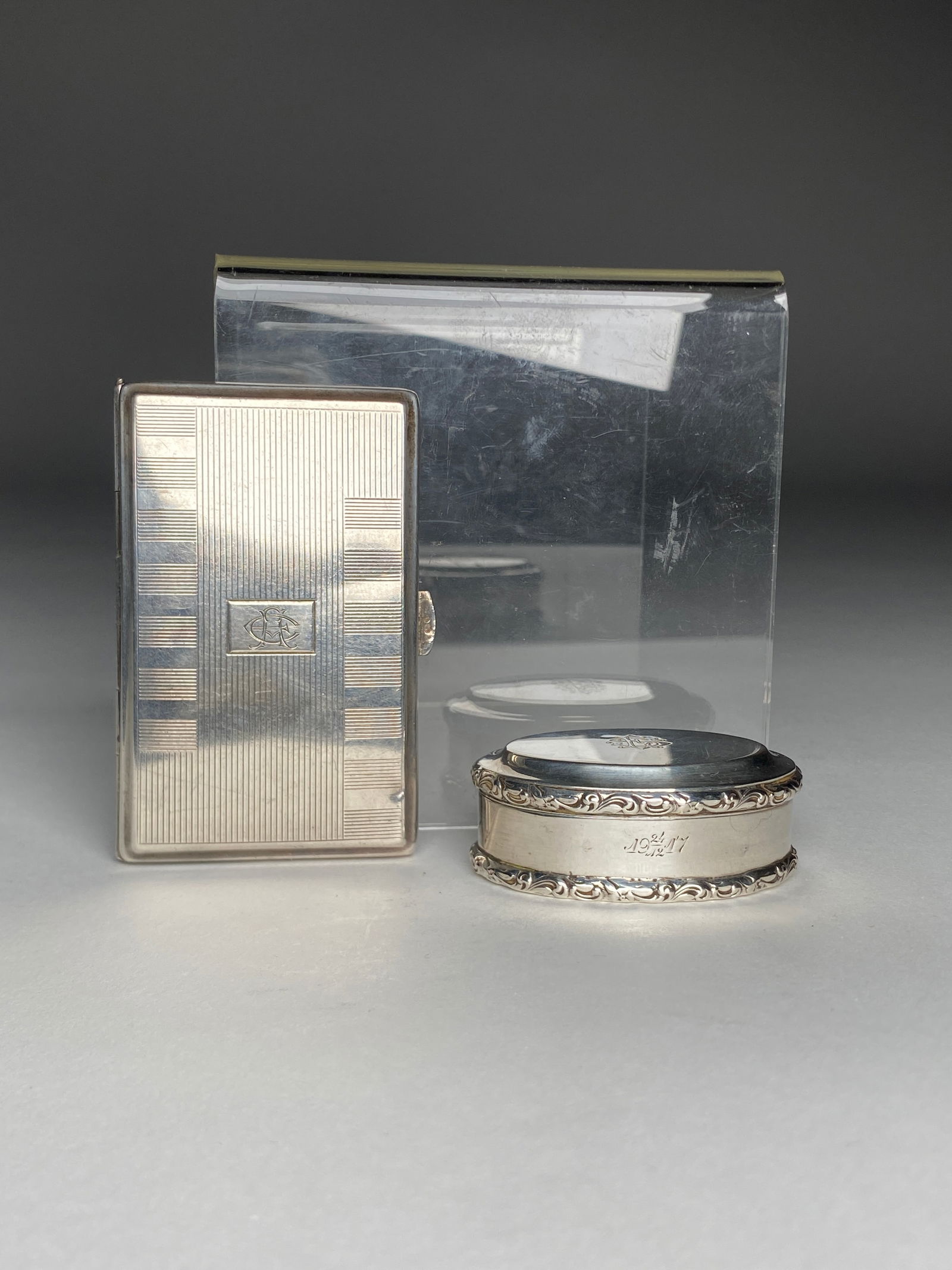 Wilhelm Muller German Silver Cigarette Case and Swedish Silver Pill Box - Early 20th Century: Wilhelm Muller German Silver Cigarette Case and Swedish Silver Pill Box - Early 20th Century On the left is a silver cigarette case by Wilhelm Muller; the rectangular form with alternating bands of ho