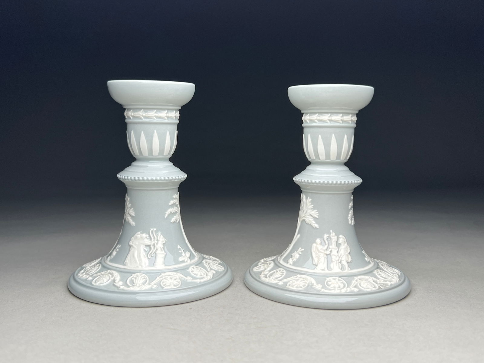 Wedgwood Green Jasperware Pair of Candlesticks - 20th Century: Wedgwood Green Jasperware Pair of Candlesticks - 20th Century Pair of Wedgwood pale sage green Jasperware candlesticks featuring classical relief decoration in white. Each candlestick has a wide circu