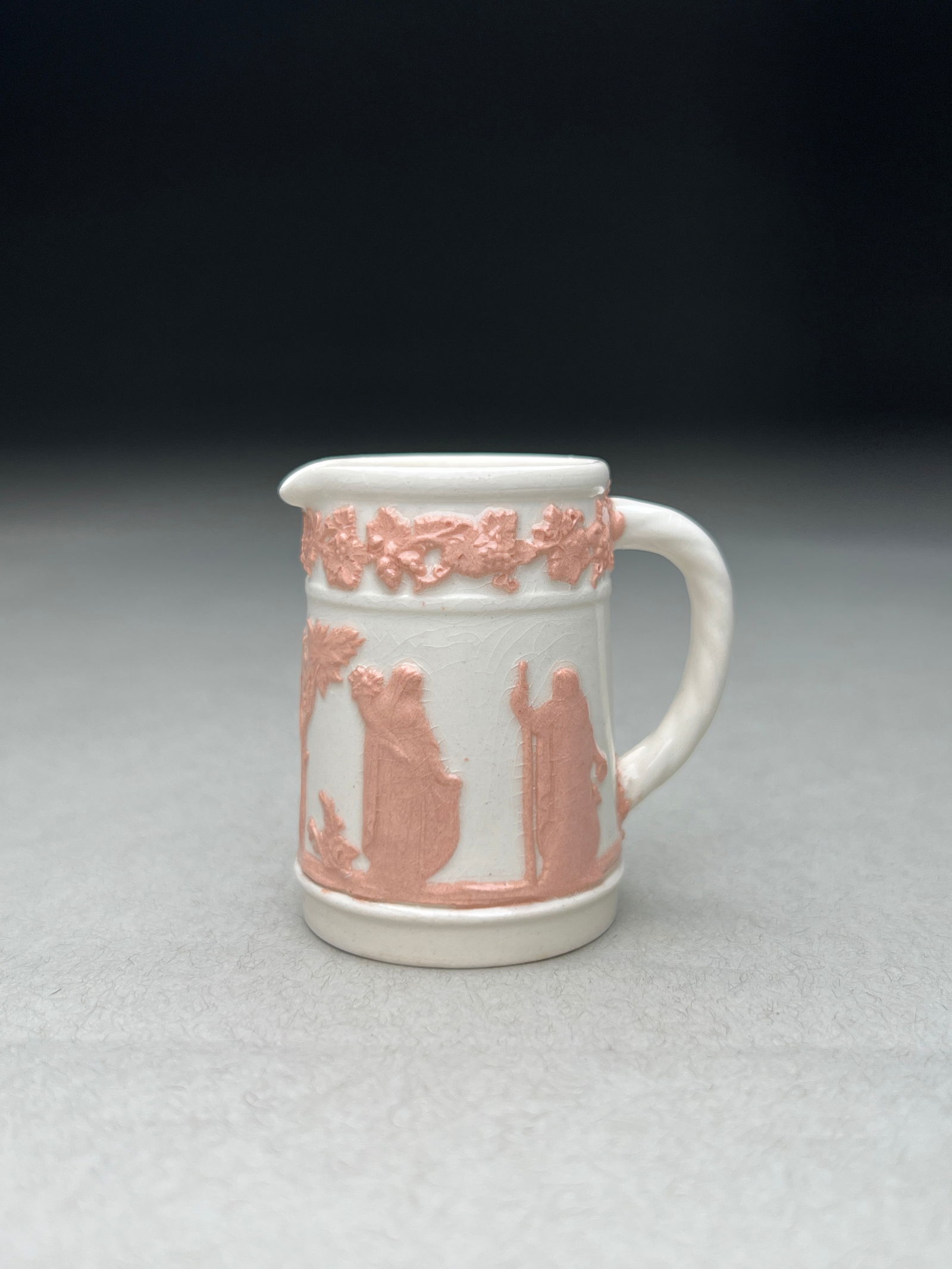 Wedgwood Jasperware miniature Creamer: Wedgwood Jasperware miniature Creamer This miniature Wedgwood jasperware creamer by Josiah Wedgwood & Sons, this elegant small creamer features applied pink relief decoration against the characteristi