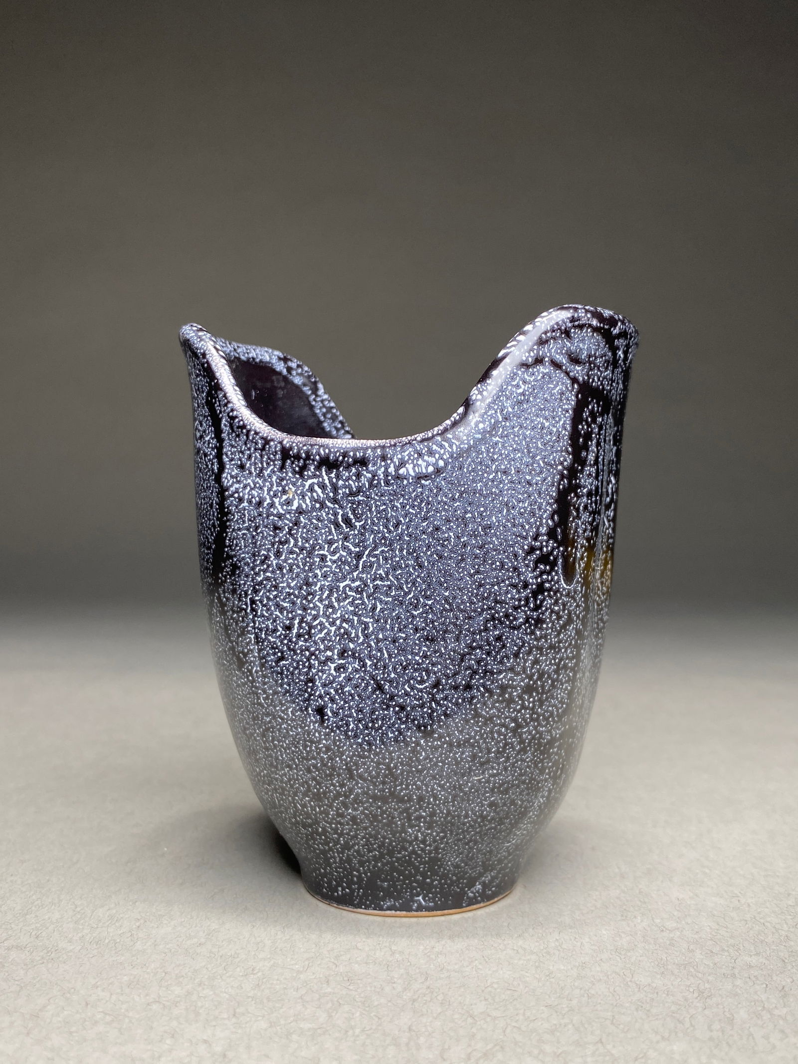 Contemporary Black and white crystalline vase, mid late 20th Century: Contemporary Black and white crystalline vase, mid late 20th Century Contemporary ceramic vessel featuring a distinctive undulating rim and a black and white crystalline glaze. This sophisticated piec