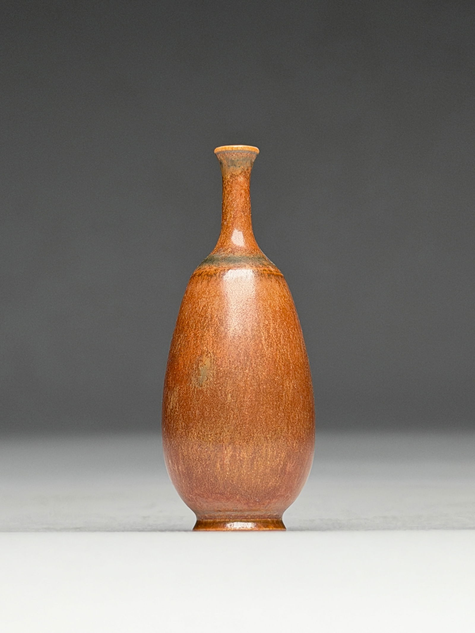 John Andersson Ceramic Orange and Brown Hues Miniature Vase - Mid 20th Century: John Andersson Ceramic Orange and Brown Hues Miniature Vase - Mid 20th Century This finely proportioned miniature vase presents a balanced, elongated ovoid body rising into a slender neck with a softl