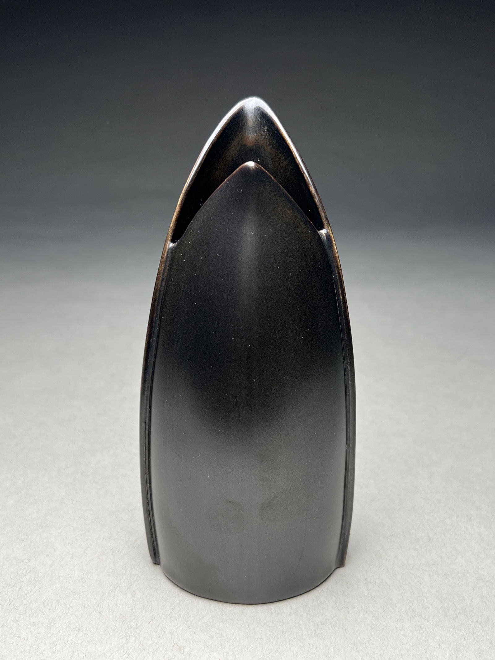 Stig Lindberg Ebony Endive Sculptural Ceramic Vase for Gustavsberg - c.1950s: Stig Lindberg Ebony Endive Sculptural Ceramic Vase for Gustavsberg - c.1950s Minimalist vase featuring a sleek sculptural form inspired by endive leaves. The piece presents as an elegant elongated pod