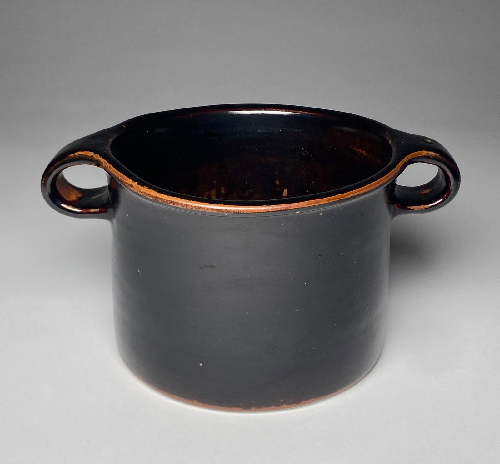 Stig Lindberg Gustavsberg Unique Stoneware Vessel with Handles - Mid 20th Century: Stig Lindberg Gustavsberg Unique Stoneware Vessel with Handles - Mid 20th Century Cylindrical in form with a deep black glaze, this vessel is accented by a warm reddish undertone that emerges along th