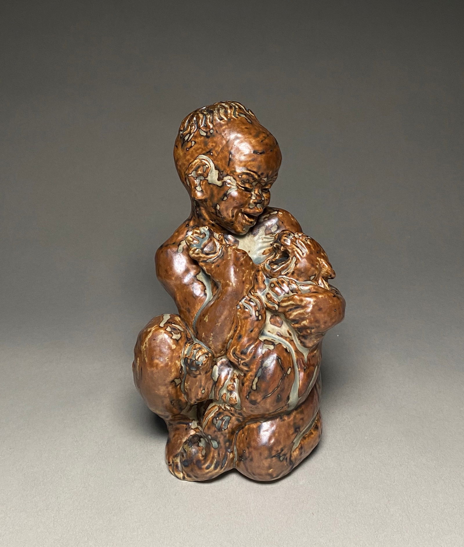 Knud Kyhn for Royal Copenhagen - Stoneware Sculpture of a Boy with Cat, c. 1930s: Knud Kyhn for Royal Copenhagen - Stoneware Sculpture of a Boy with Cat, c. 1930s A expressive stoneware sculpture by Knud Kyhn for Royal Copenhagen, dating to the 1930s. This modernist figurine depict